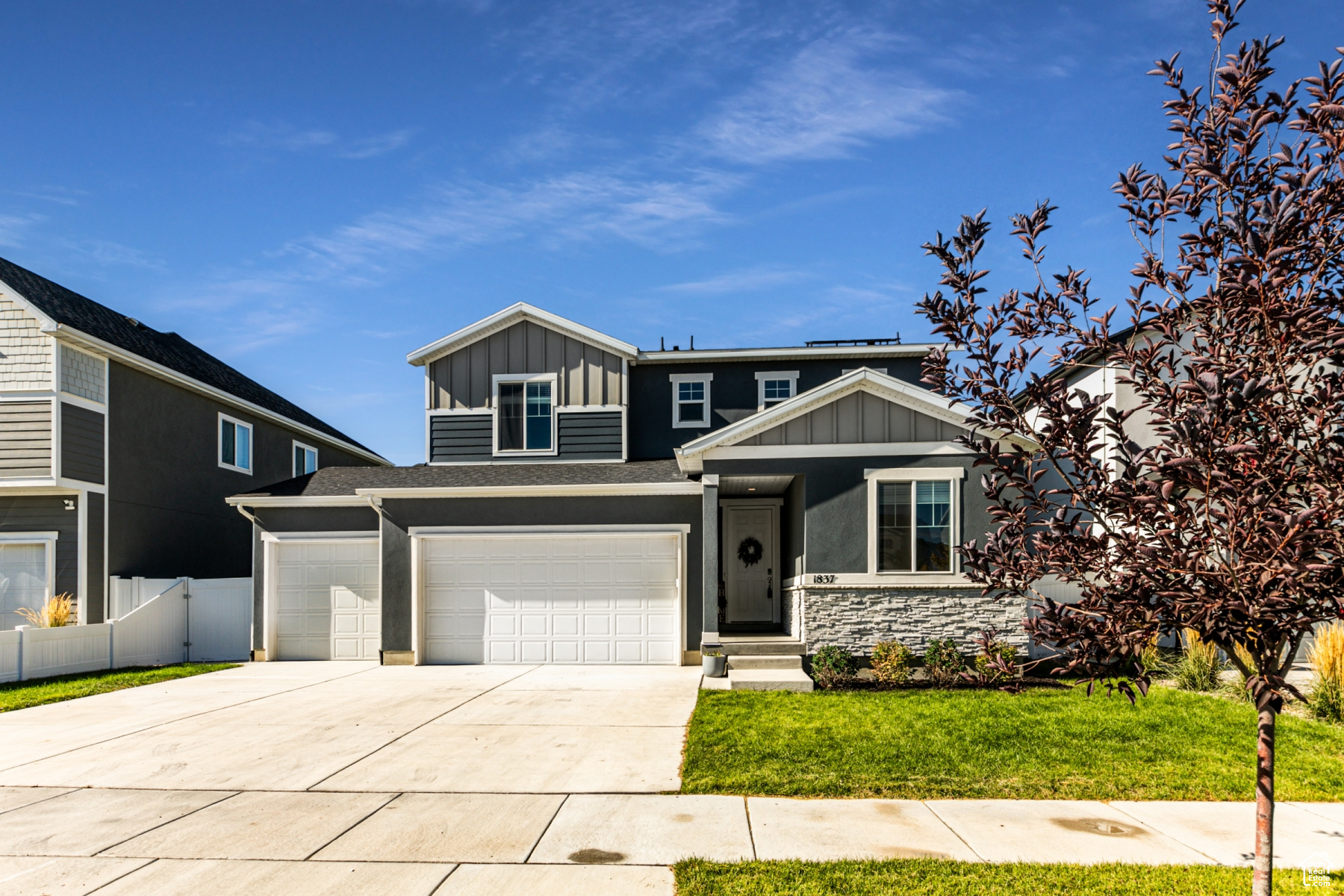 View of front of house with a front yard and a garage