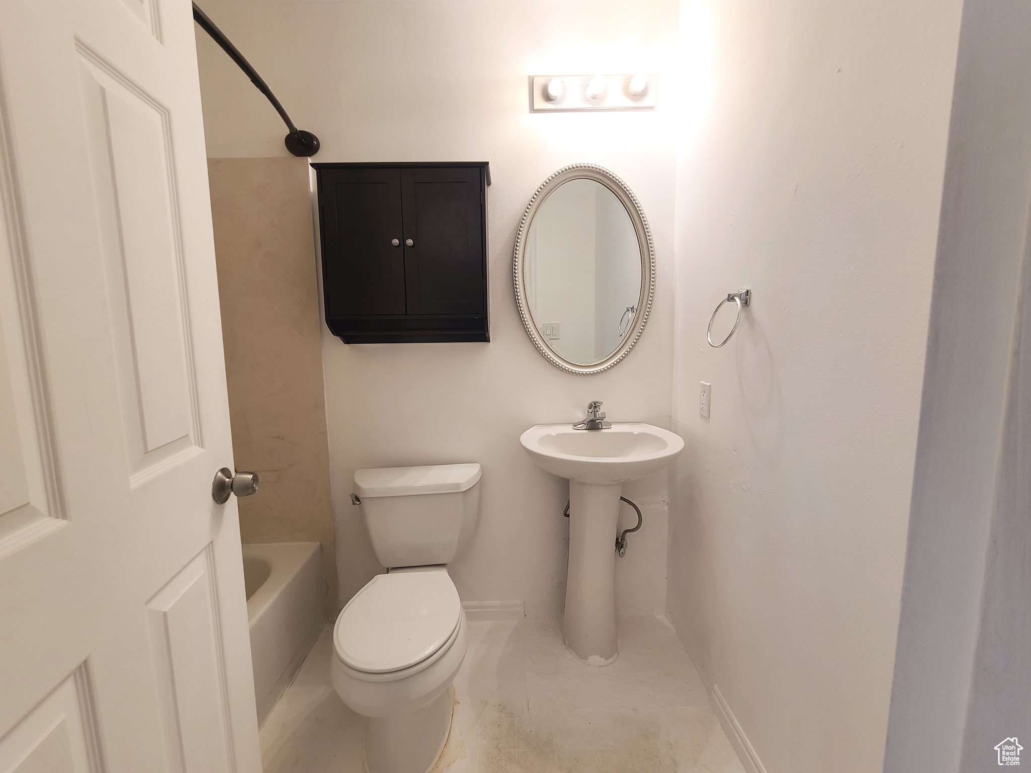 Bathroom featuring bathing tub / shower combination and toilet