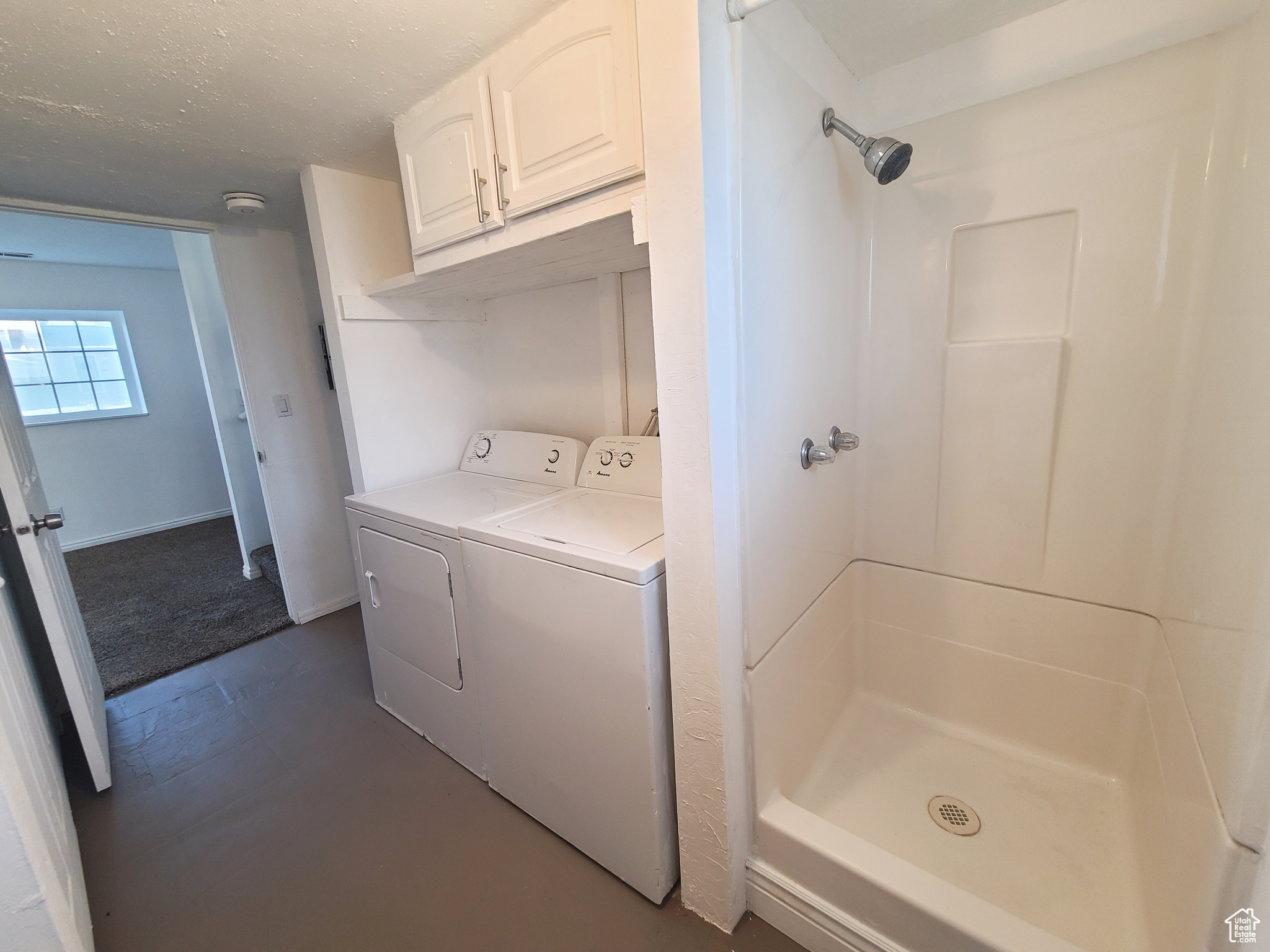 Combination laundry and bathroom featuring a washer and dryer