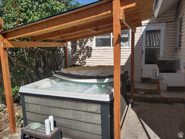 View of patio / terrace featuring a hot tub