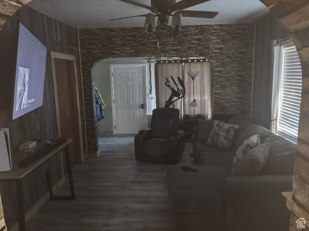 Living room featuring a textured ceiling, hardwood / wood-style floors, and ceiling fan