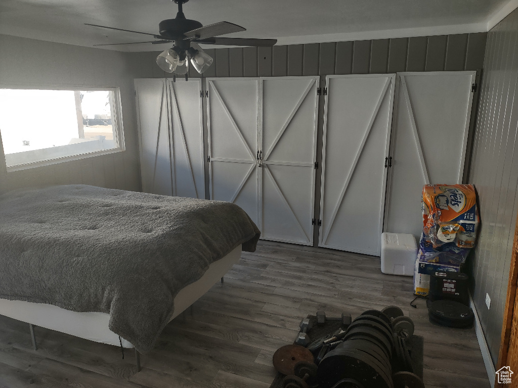 Bedroom featuring ceiling fan and dark hardwood / wood-style flooring