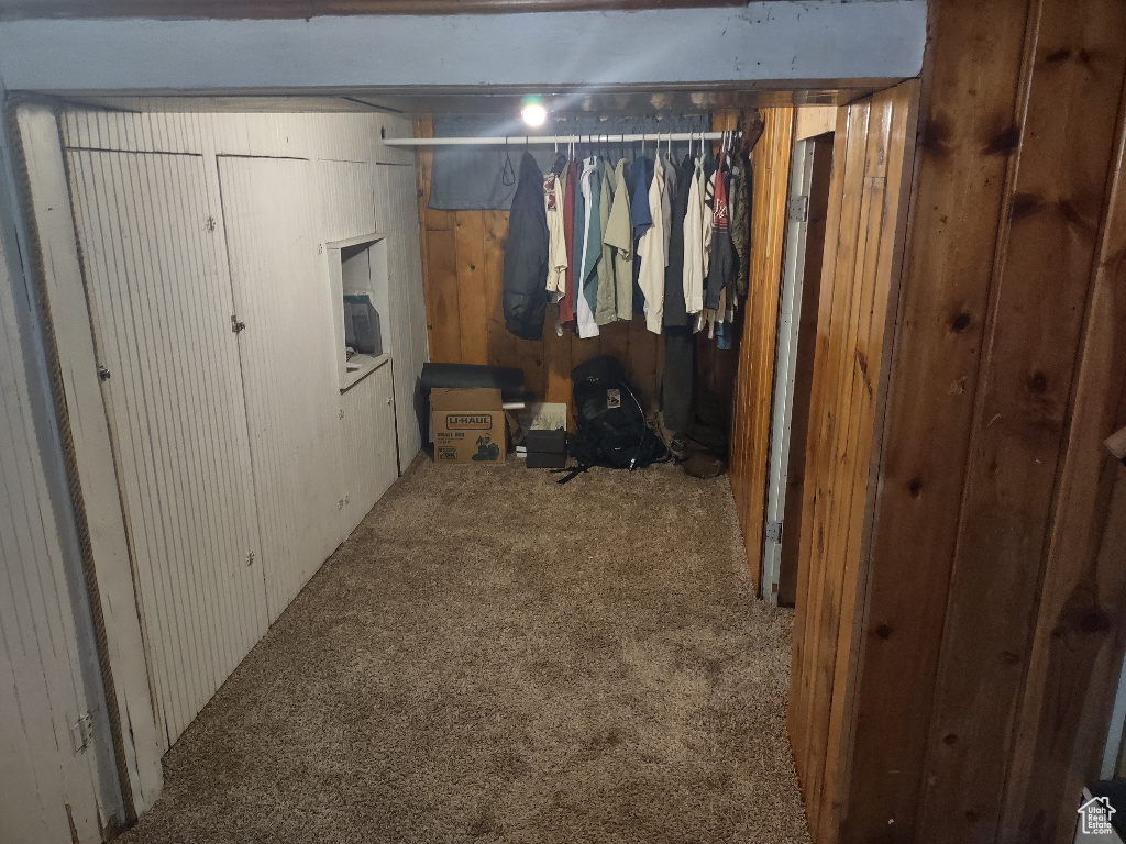 Carpeted bedroom with wooden walls