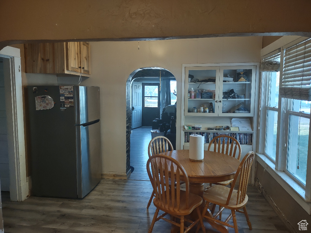 Dining space with hardwood / wood-style floors