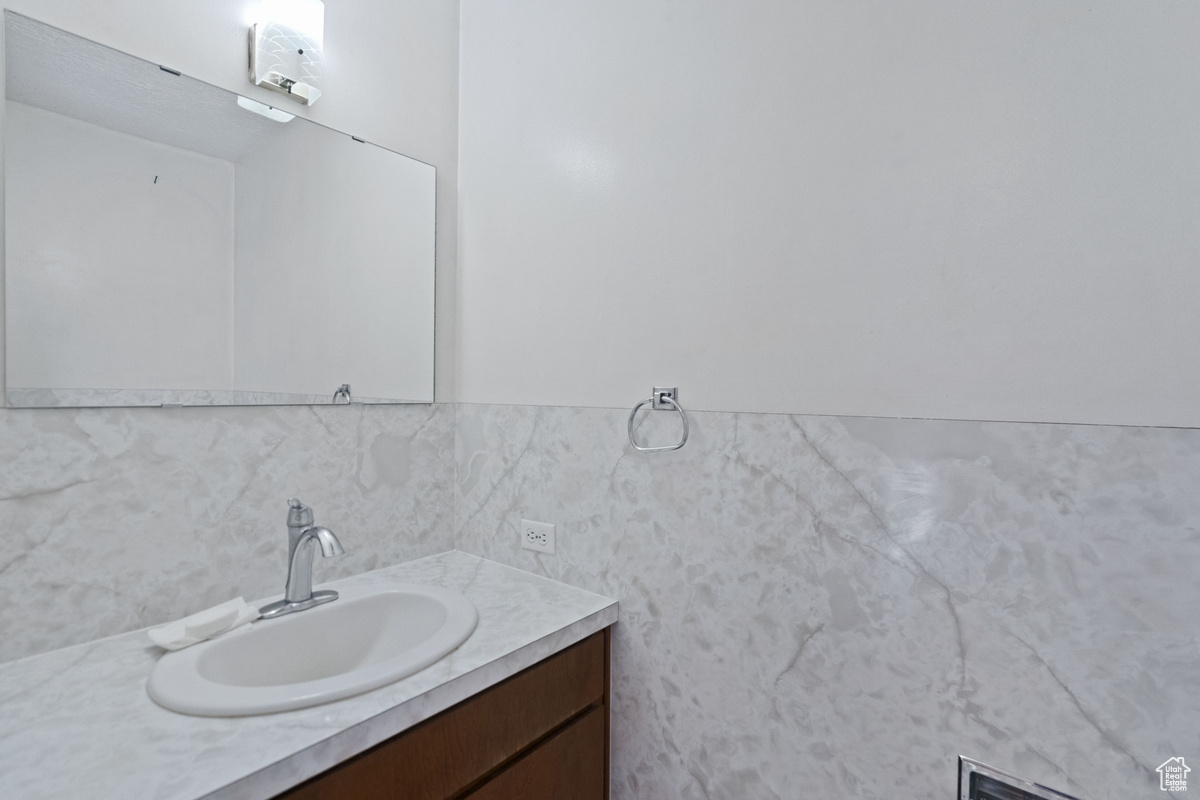 Bathroom with decorative backsplash and vanity