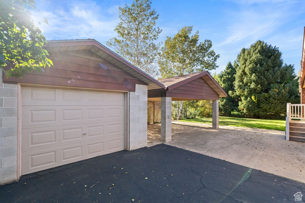 Garage featuring a carport