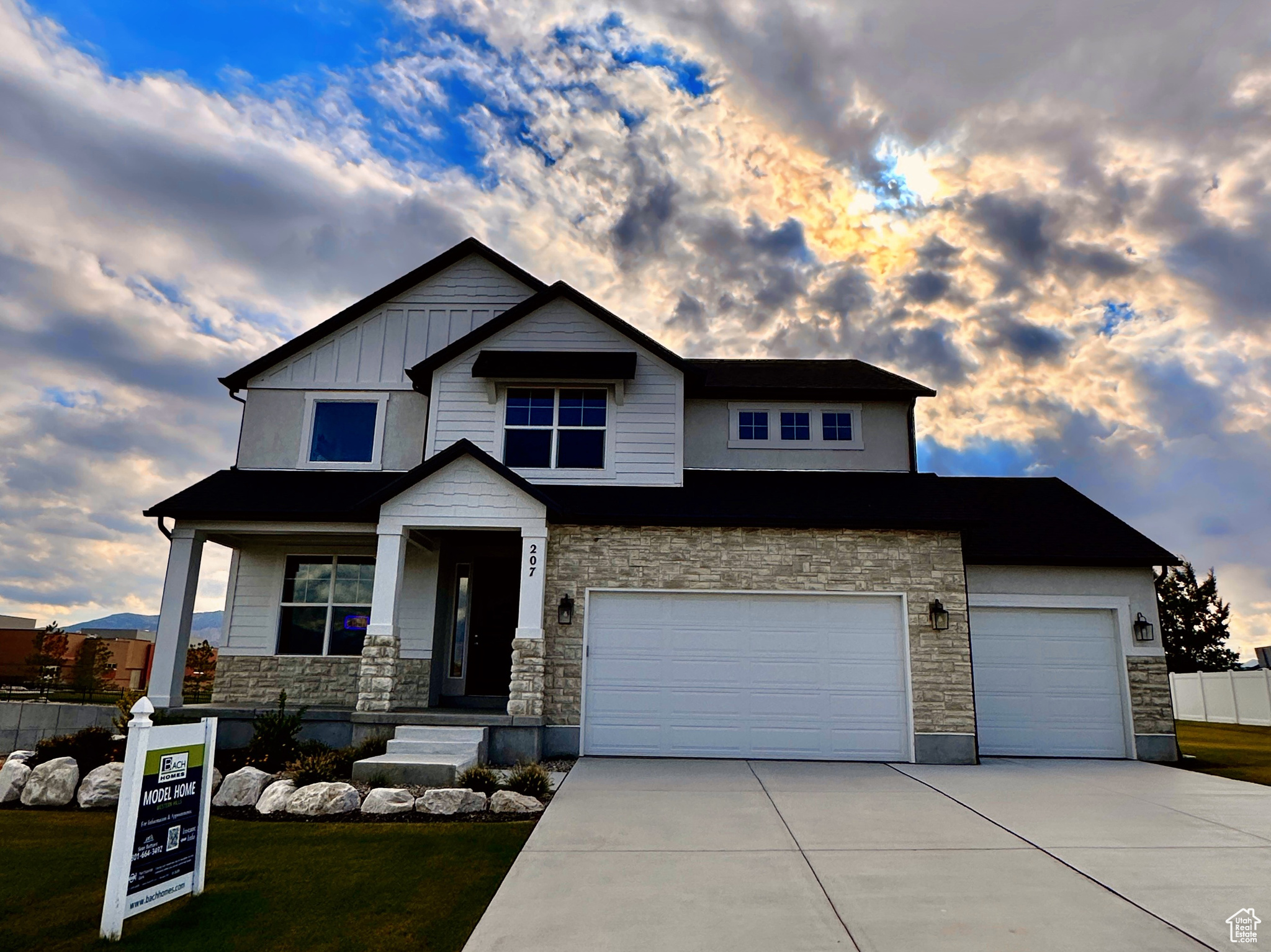 Craftsman inspired home featuring a yard, covered porch, and a garage