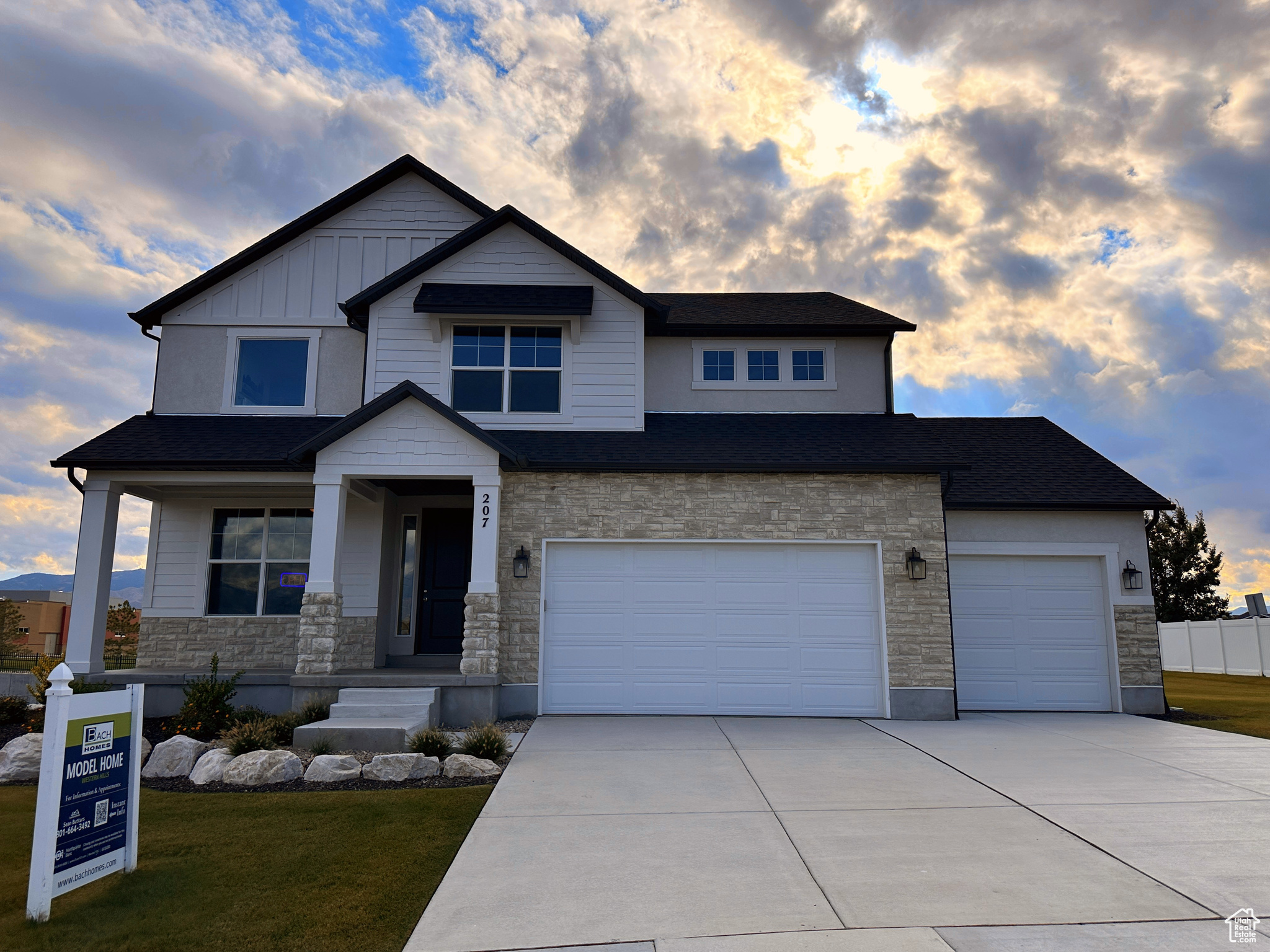 Craftsman-style house with a yard, a porch, and a garage