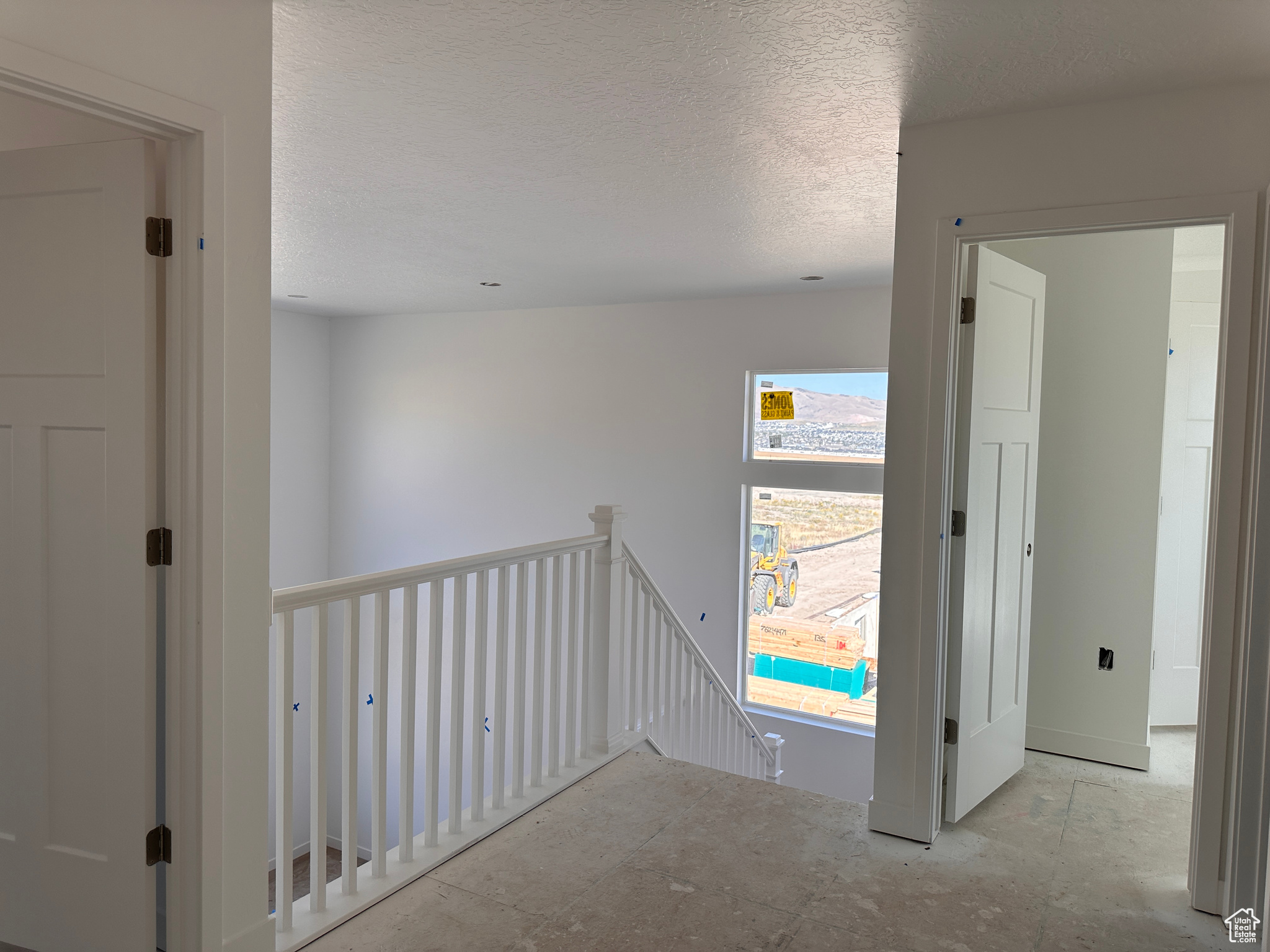 Hall with a textured ceiling and a wealth of natural light