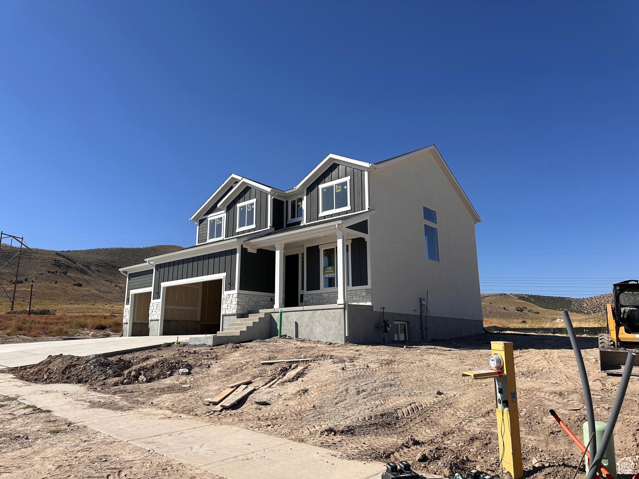 View of front of house with a mountain view, a garage, and a porch