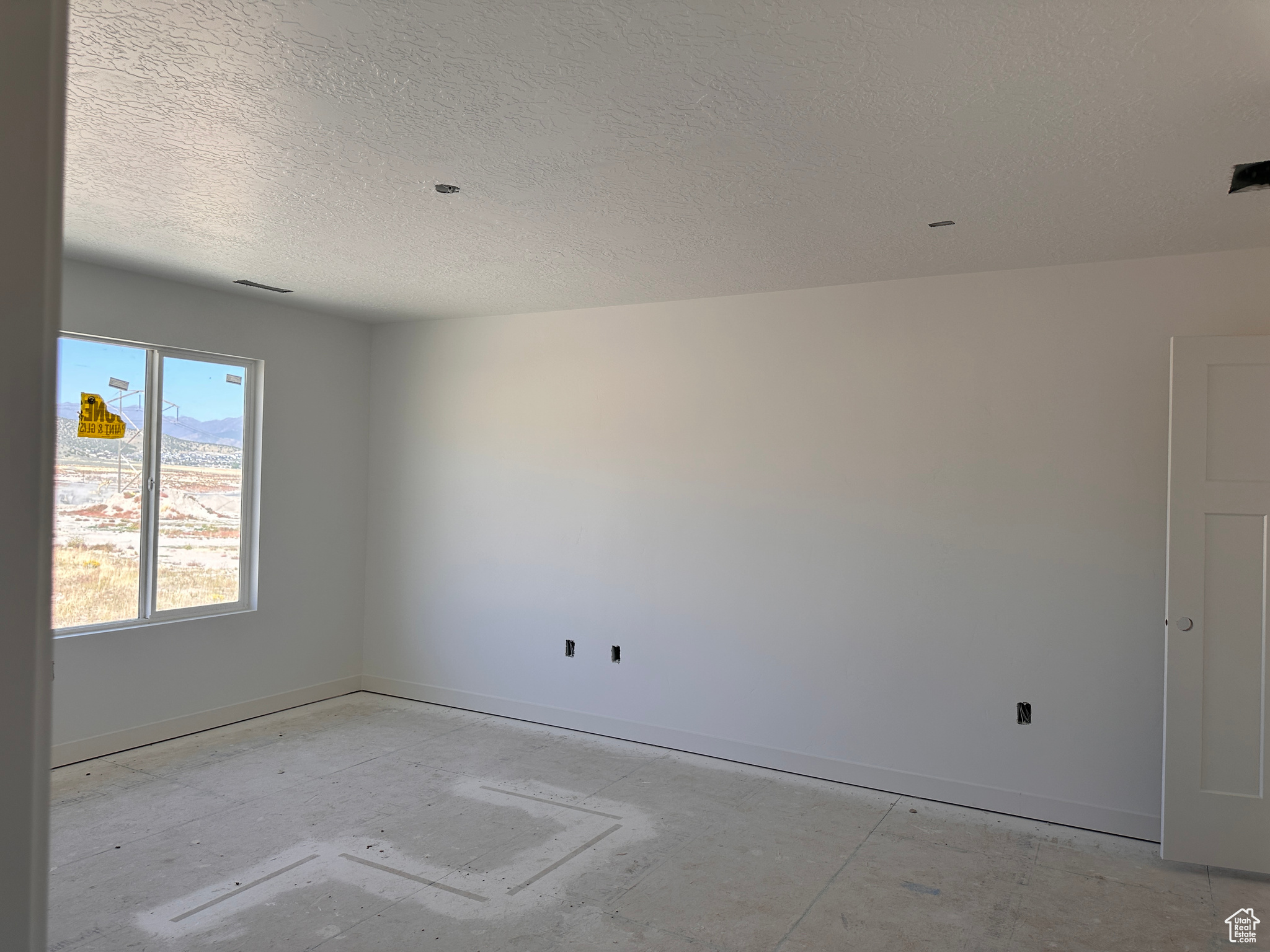 Empty room with a textured ceiling