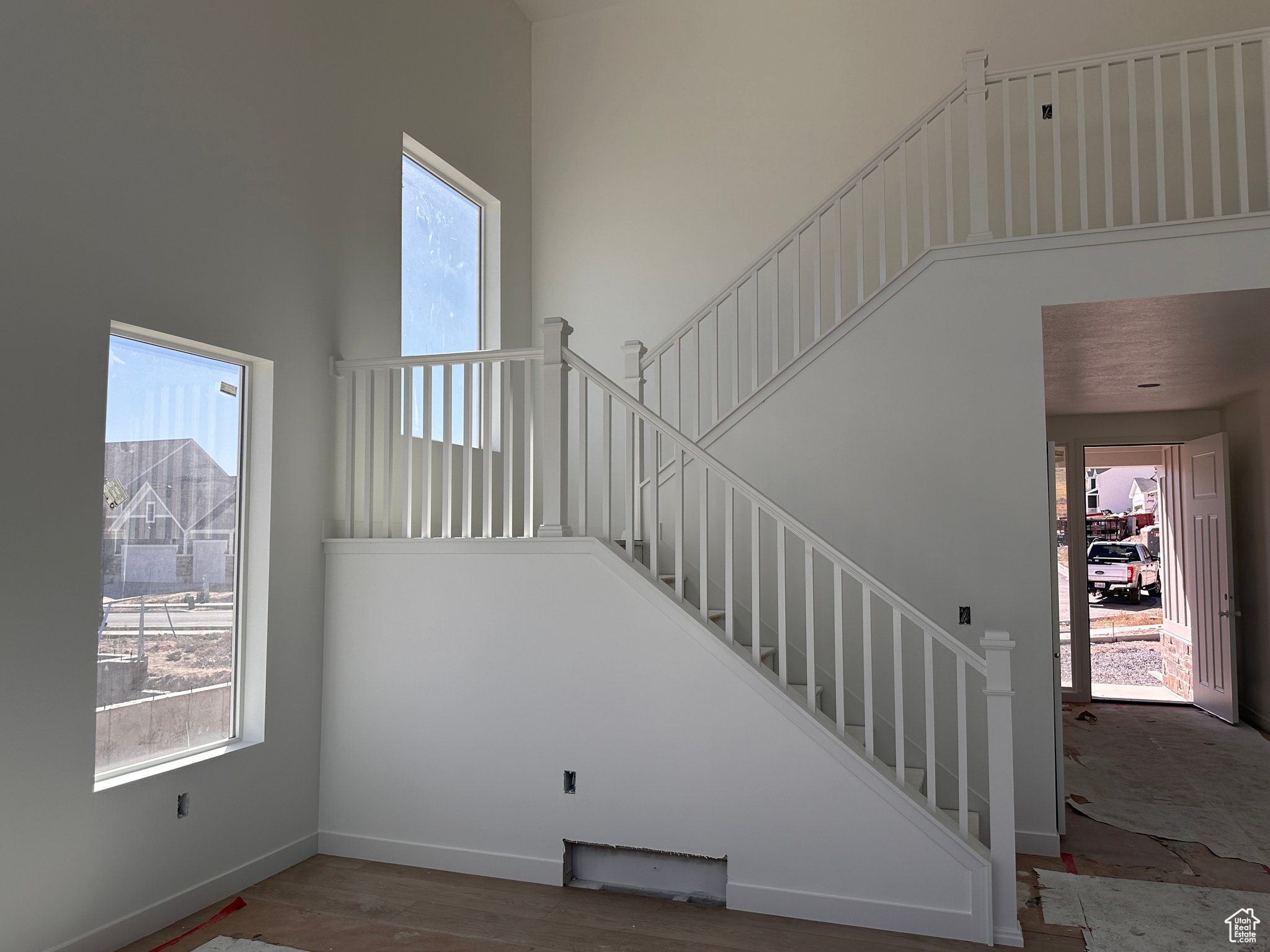 Staircase featuring a wealth of natural light and hardwood / wood-style floors