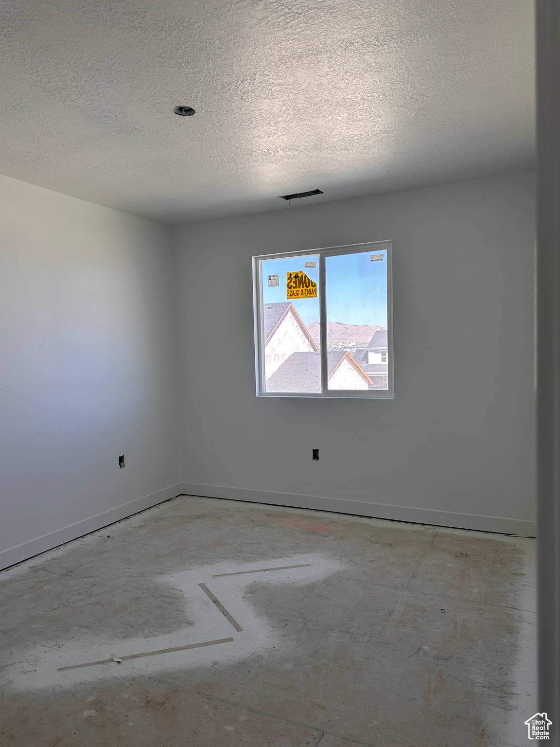 Empty room featuring a textured ceiling