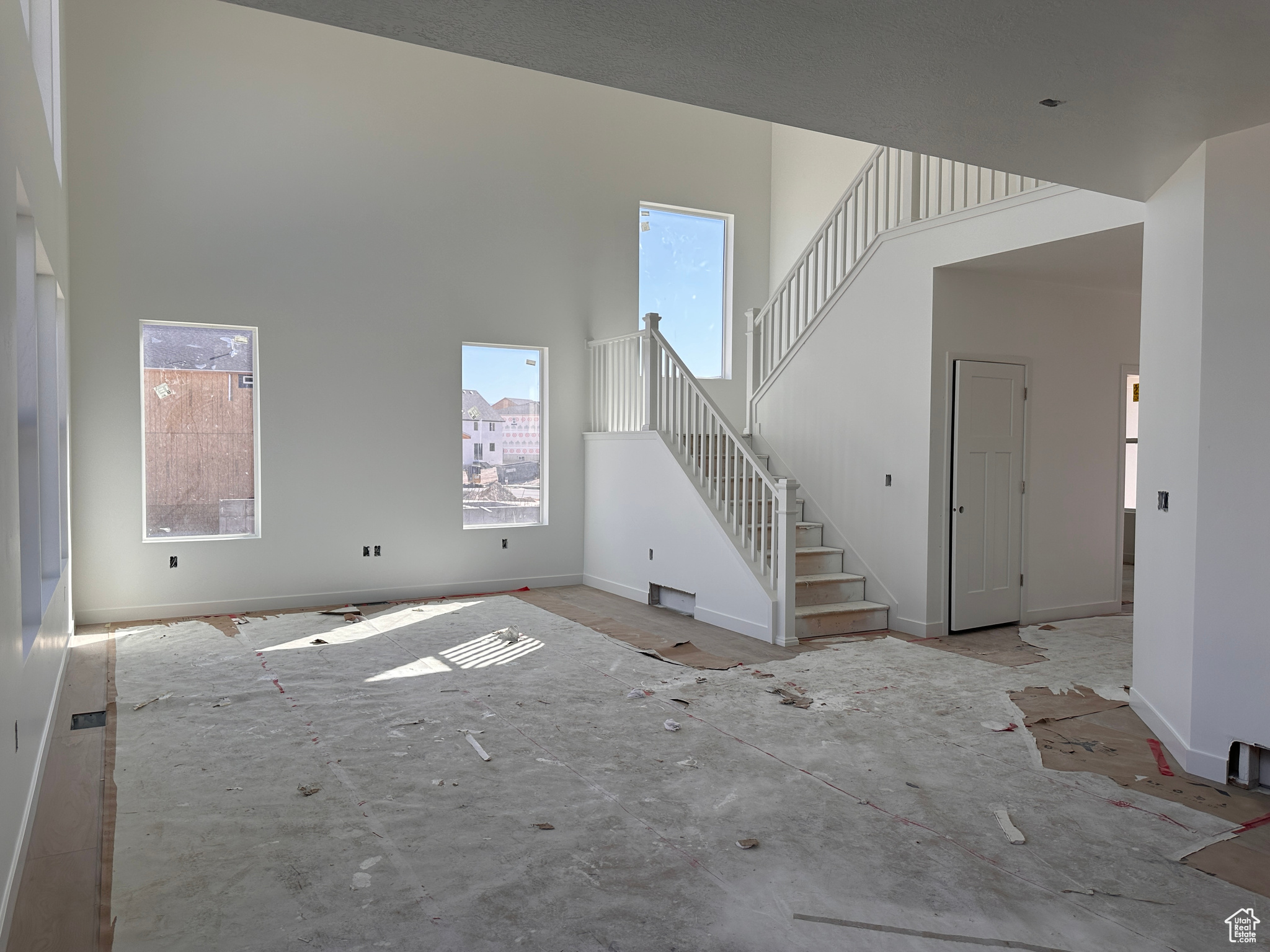 Unfurnished living room with a high ceiling