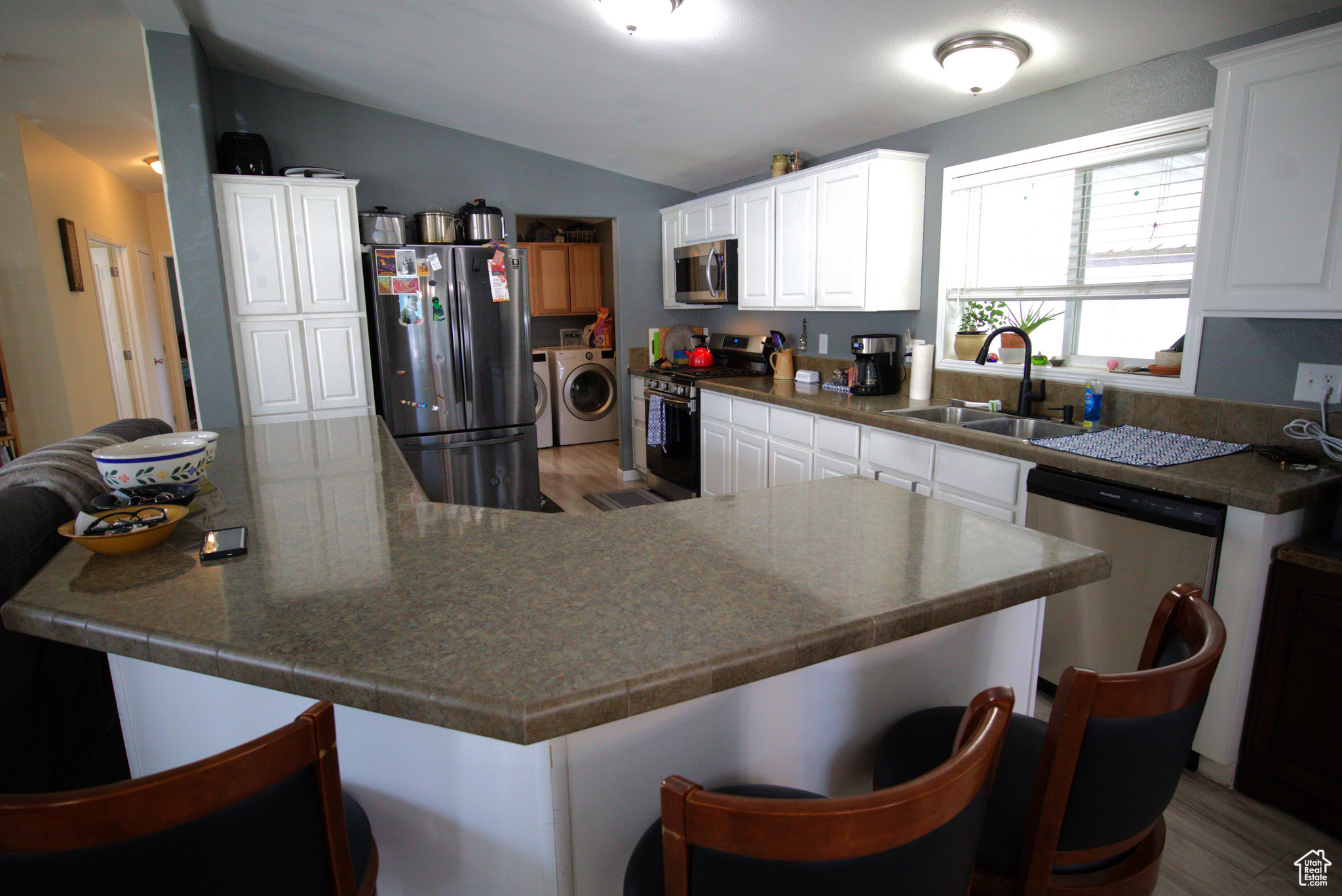 Large counter with storage cabinets and seating