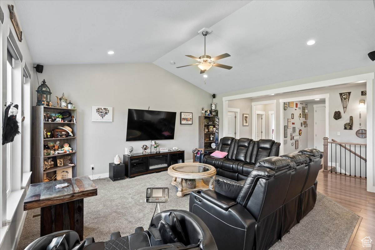 Living room featuring wood-type flooring, lofted ceiling, and ceiling fan