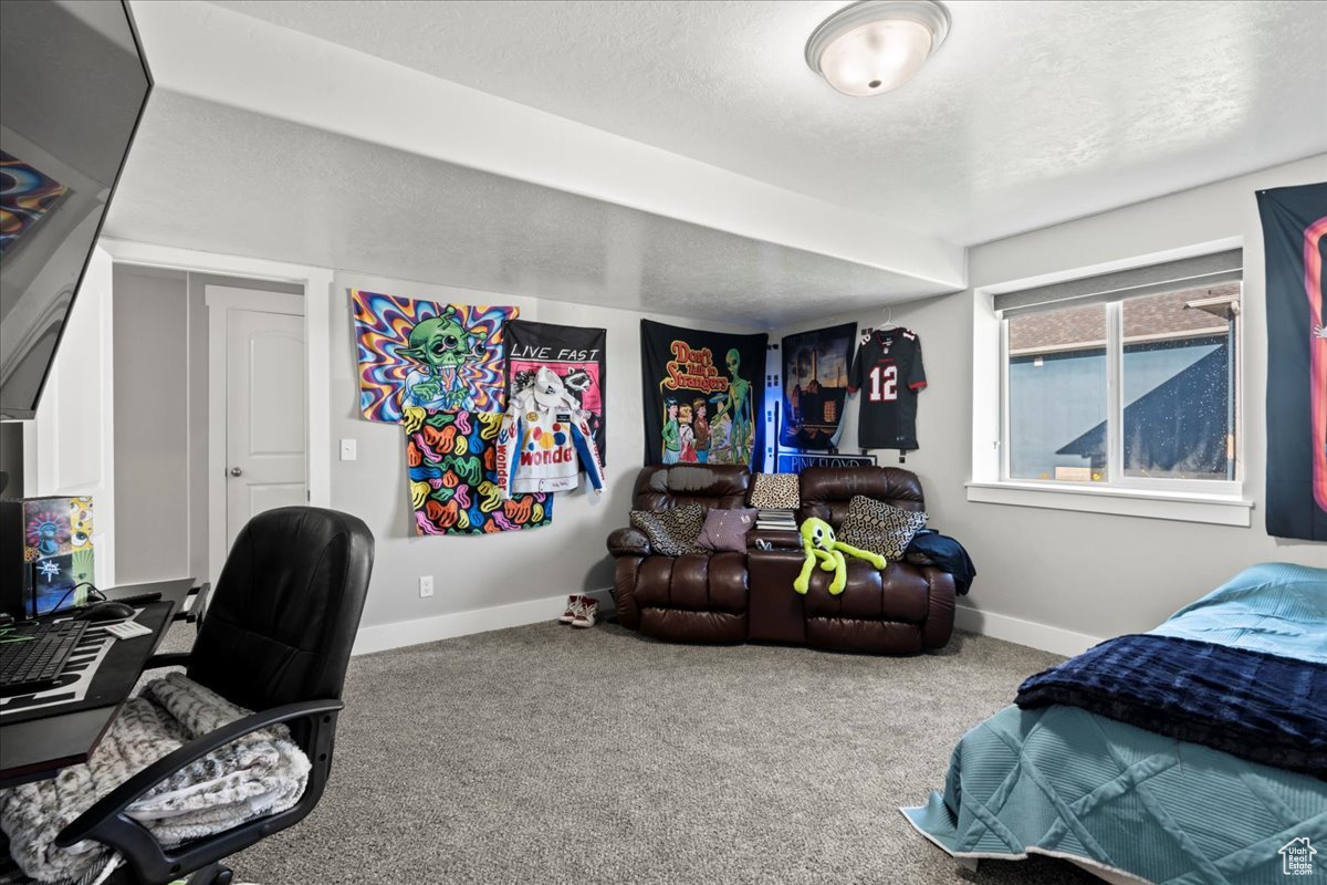 Bedroom featuring a textured ceiling and carpet