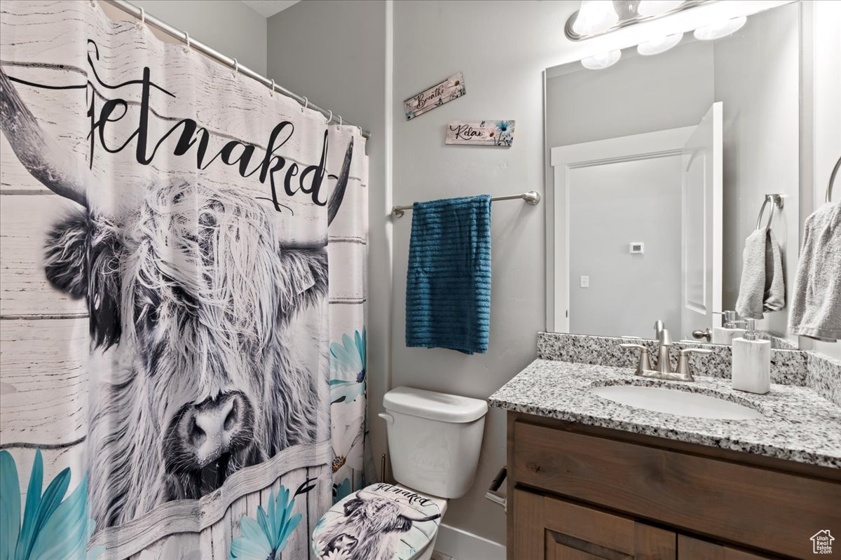 Bathroom with walk in shower, vanity, and toilet