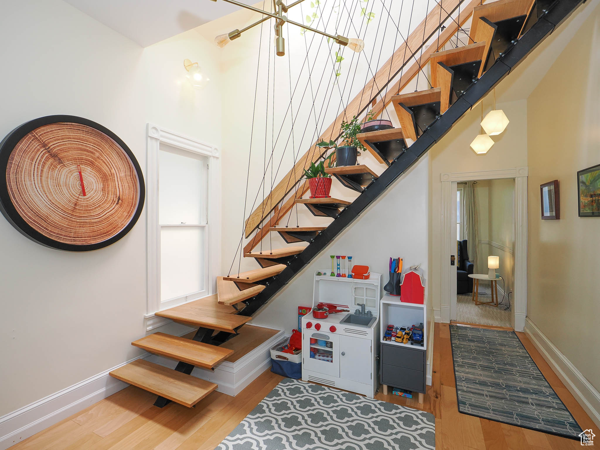 Stairway featuring a high ceiling and hardwood / wood-style floors