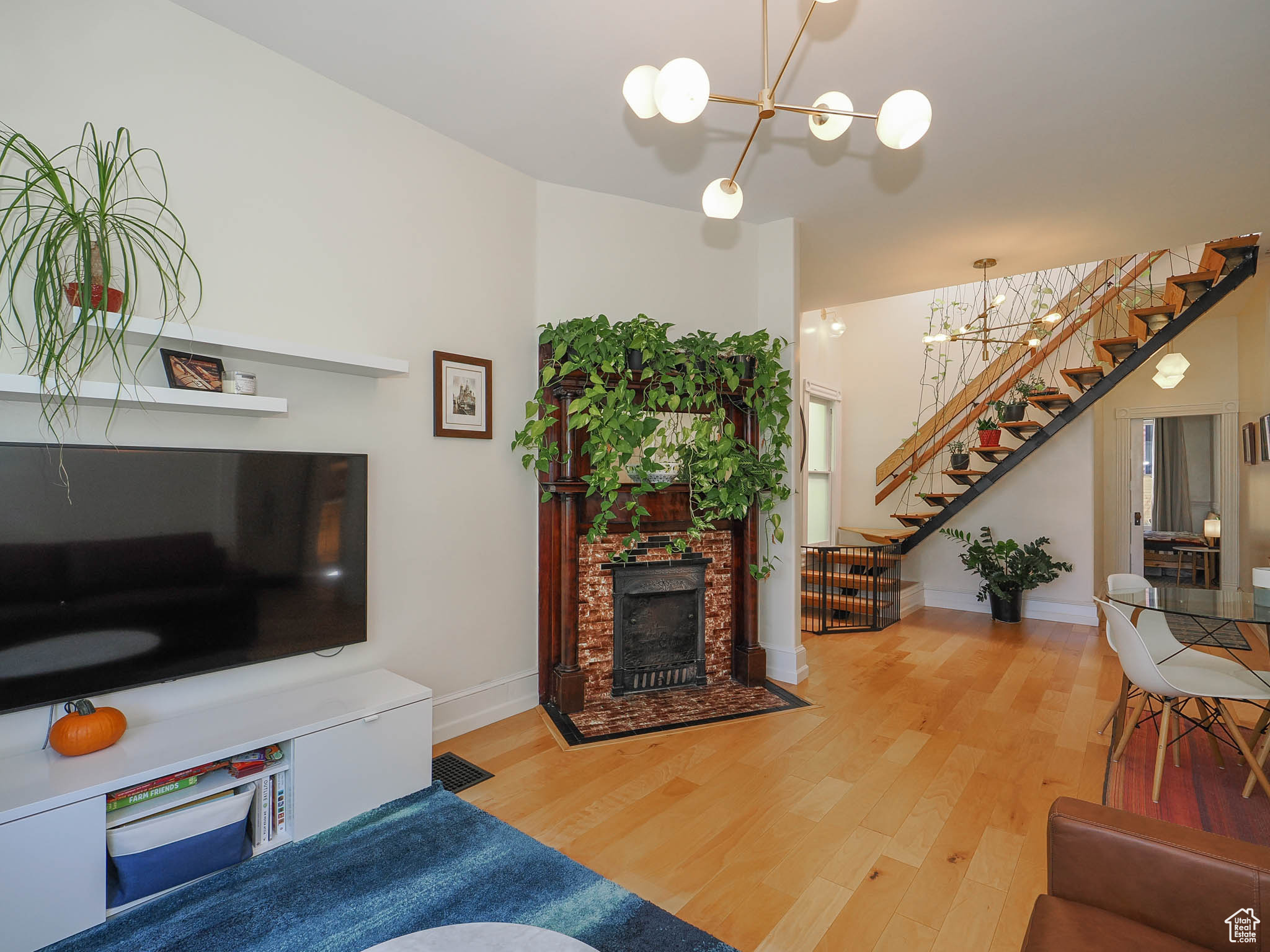 Living room featuring hardwood / wood-style floors and a notable chandelier