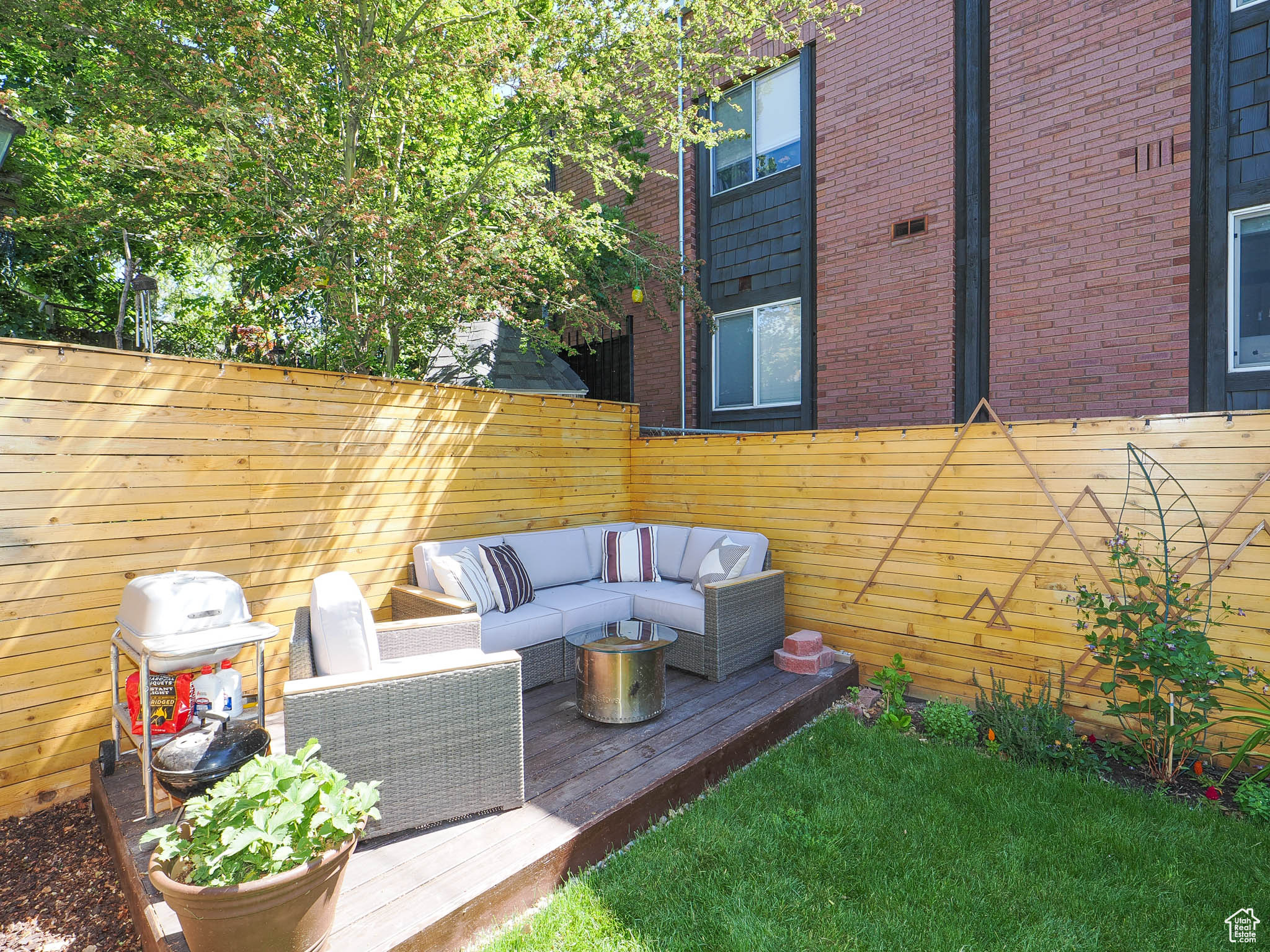 View of patio / terrace with a wooden deck, an outdoor hangout area, and a grill