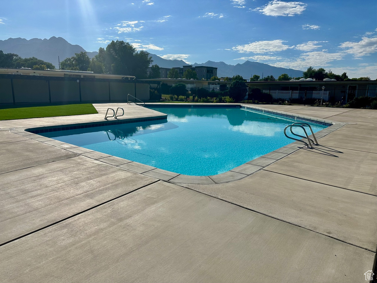 View of pool with a mountain view and a patio area