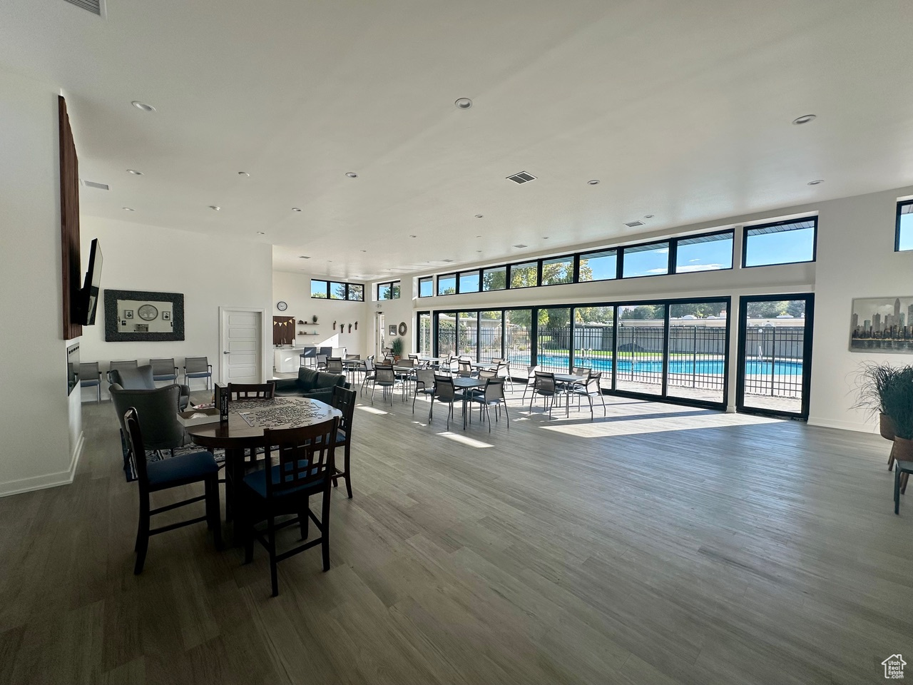 Dining area featuring hardwood / wood-style flooring and a towering ceiling