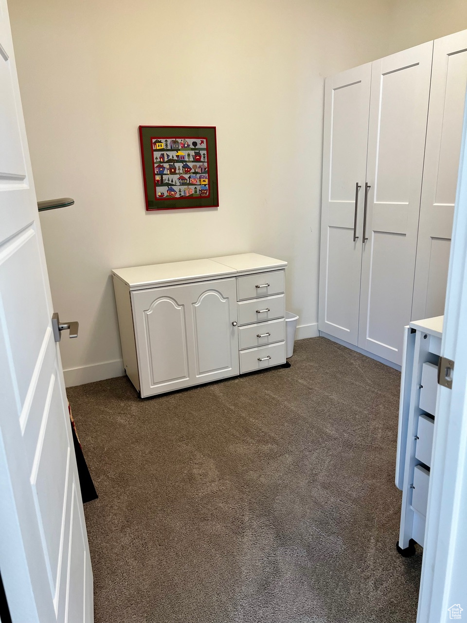 Bedroom with dark colored carpet