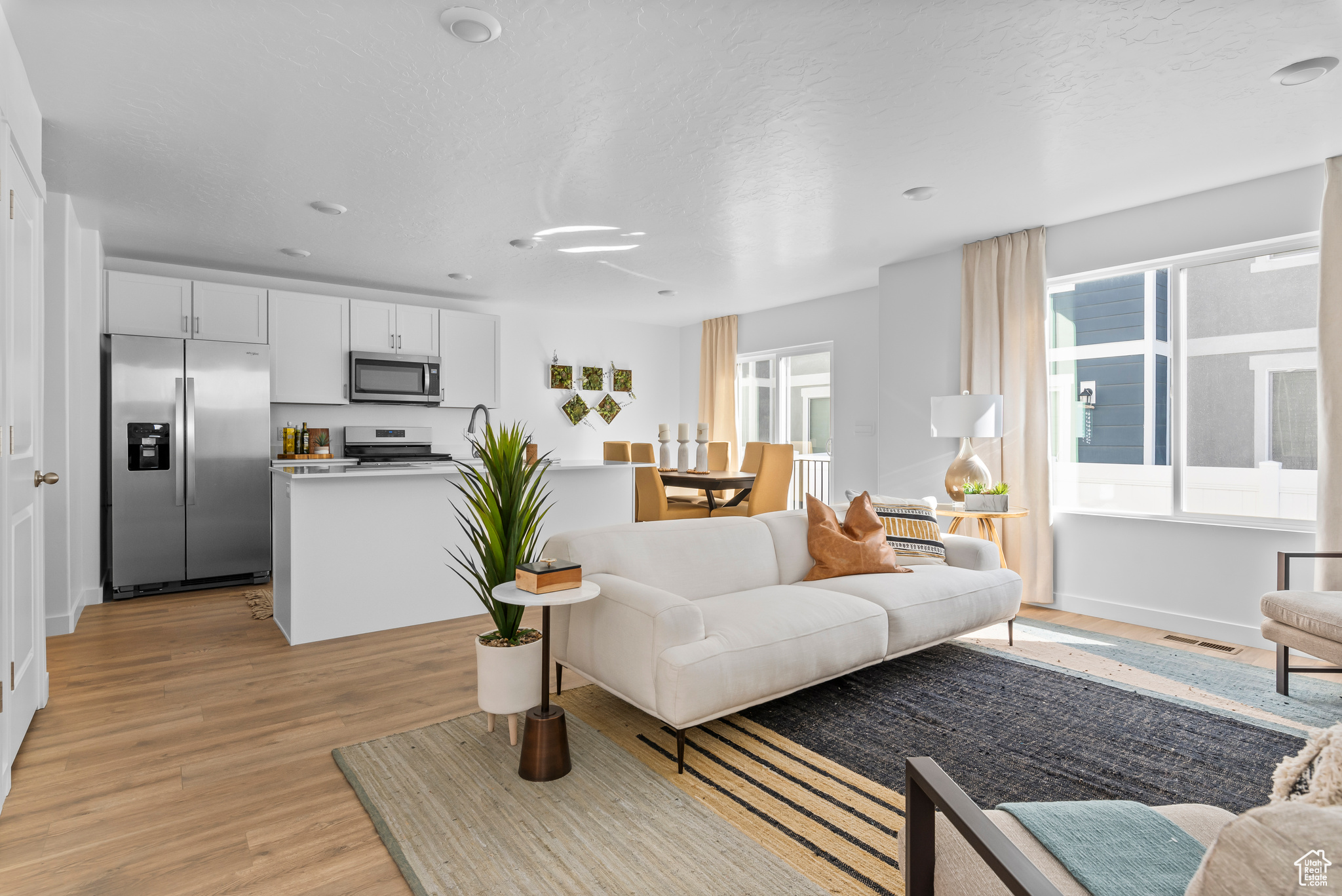 Living room featuring a textured ceiling and light wood-type flooring