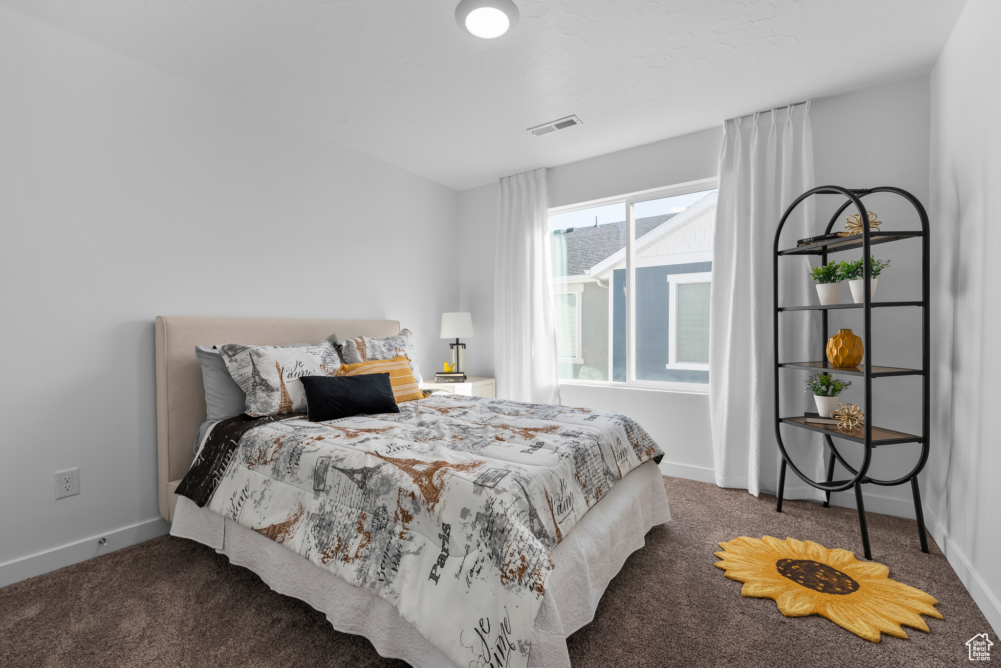 Bedroom with dark colored carpet