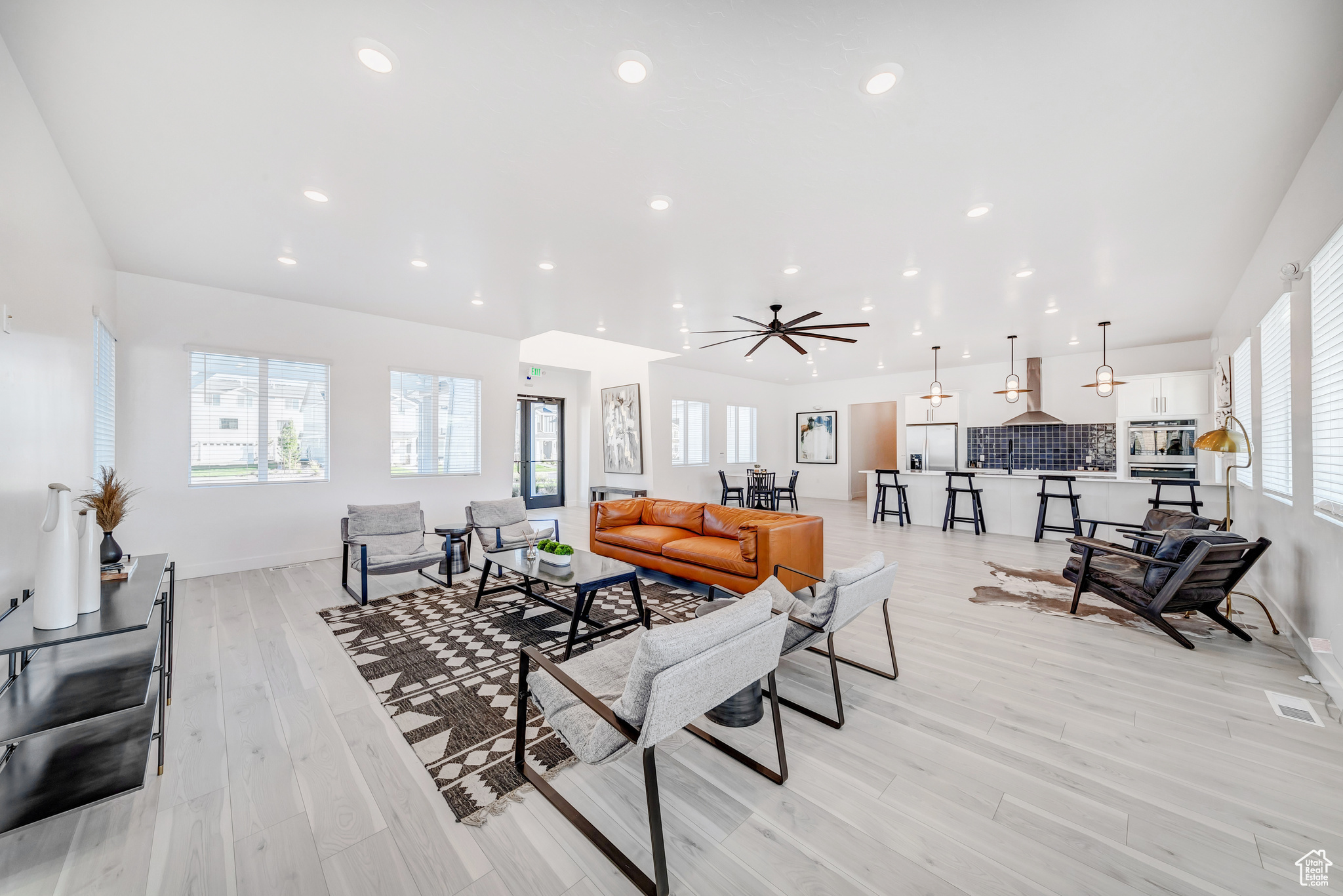 Living room featuring ceiling fan and light wood-type flooring