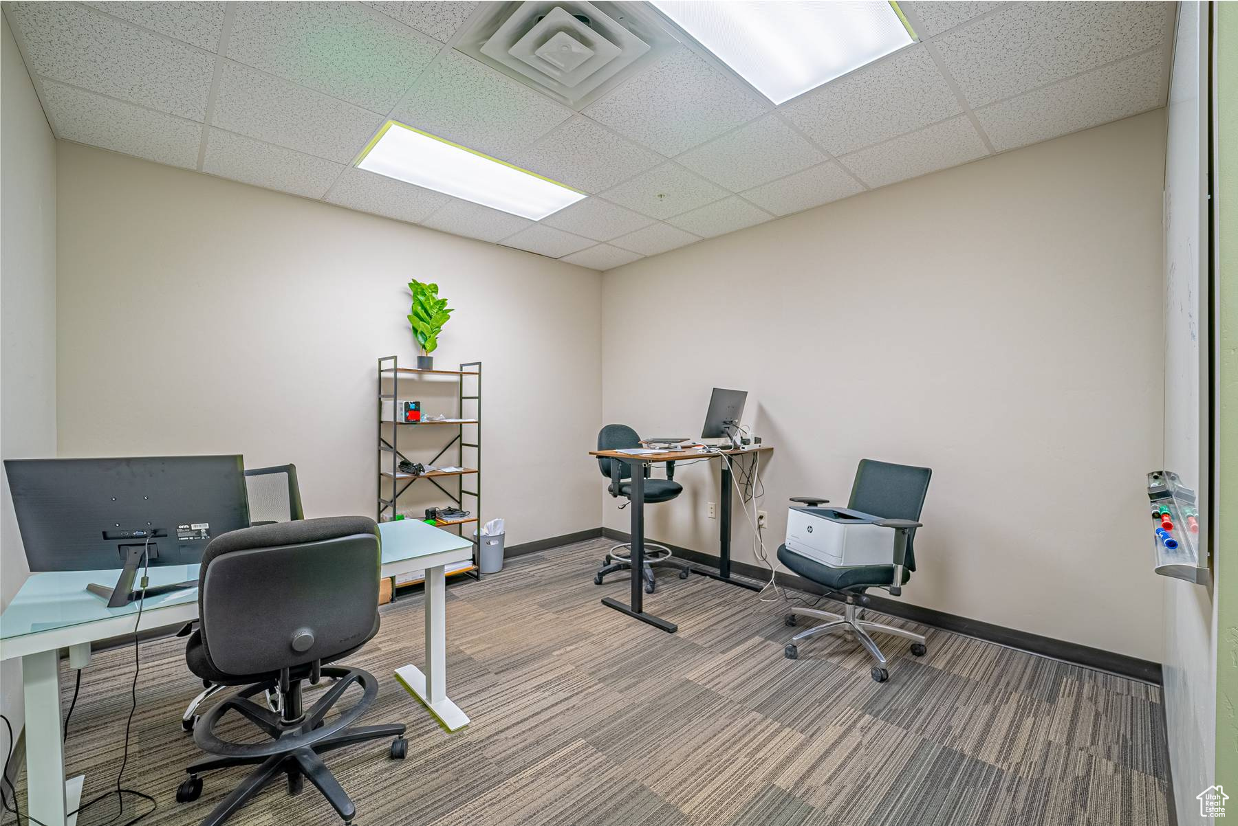 Office with a paneled ceiling