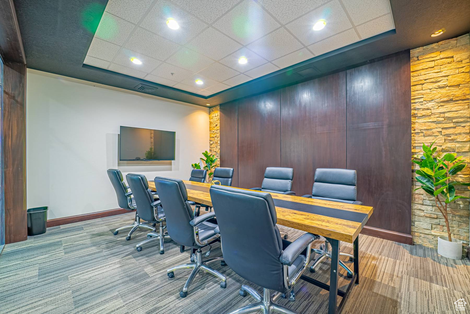 Carpeted home office with a drop ceiling