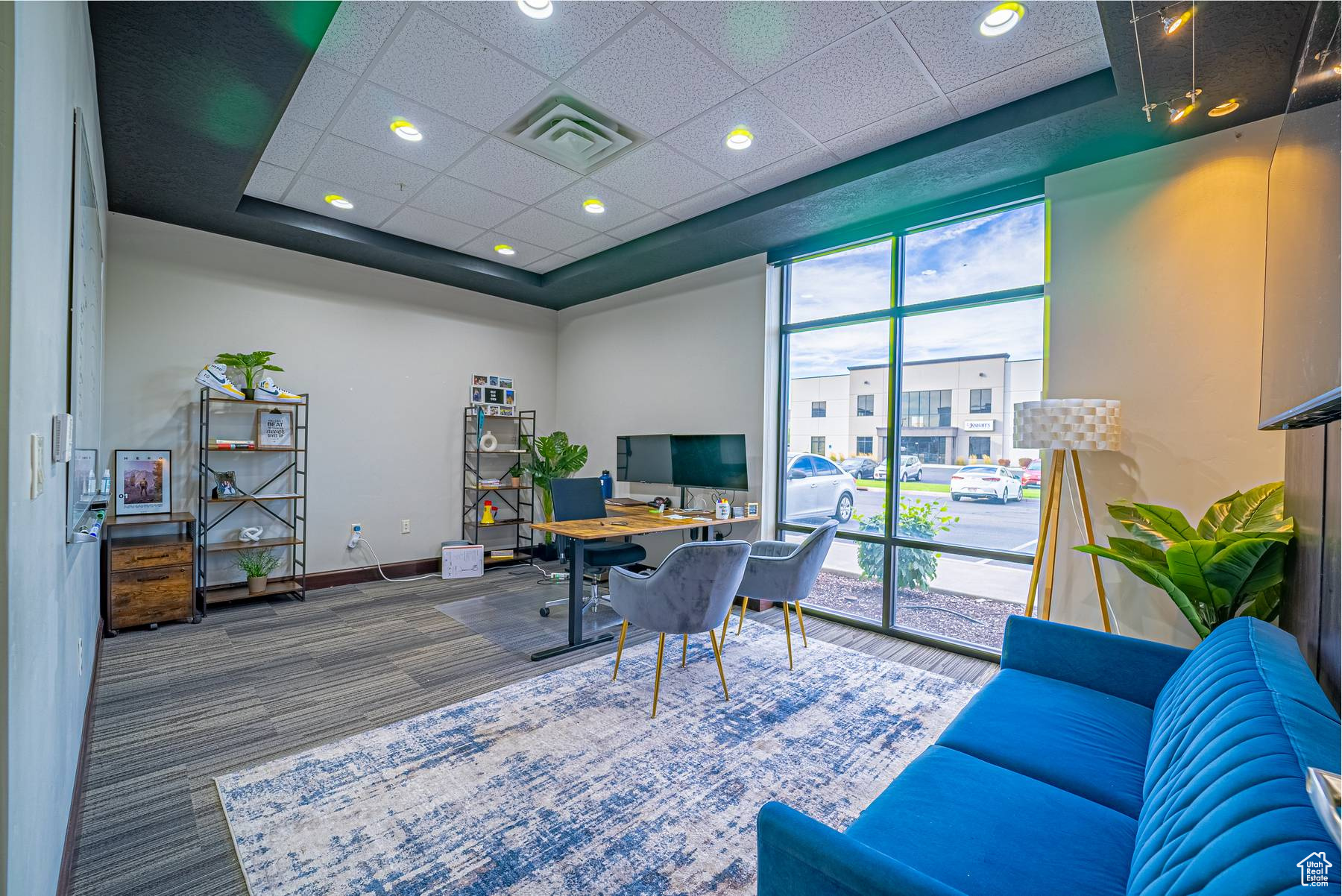 Office featuring a drop ceiling and a wealth of natural light