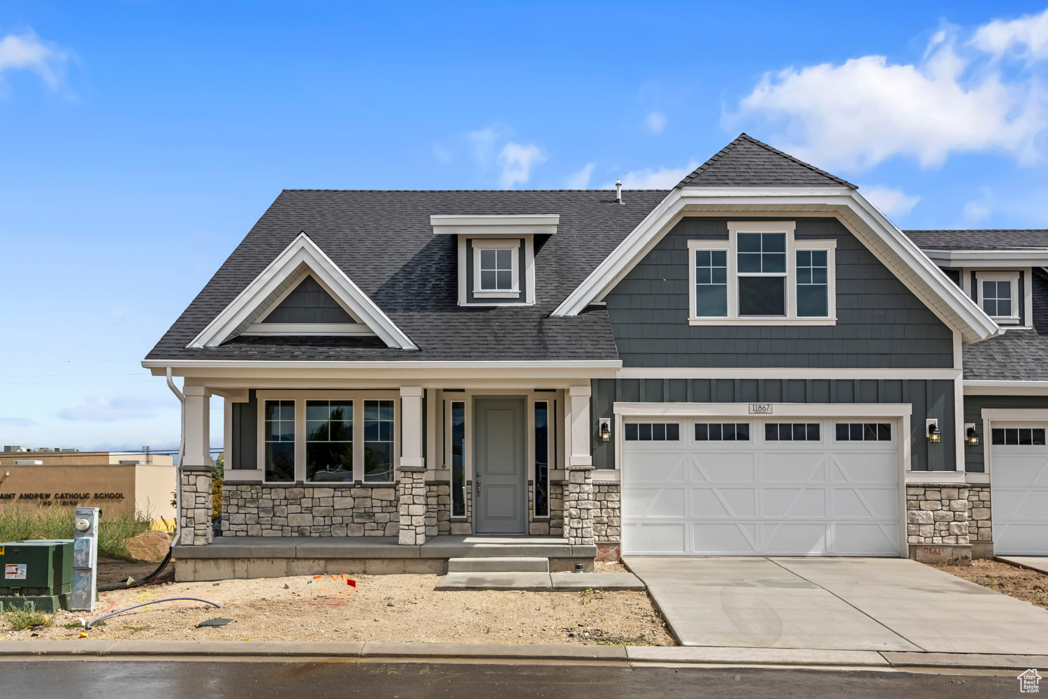 Craftsman-style house with a porch, a garage, and central AC