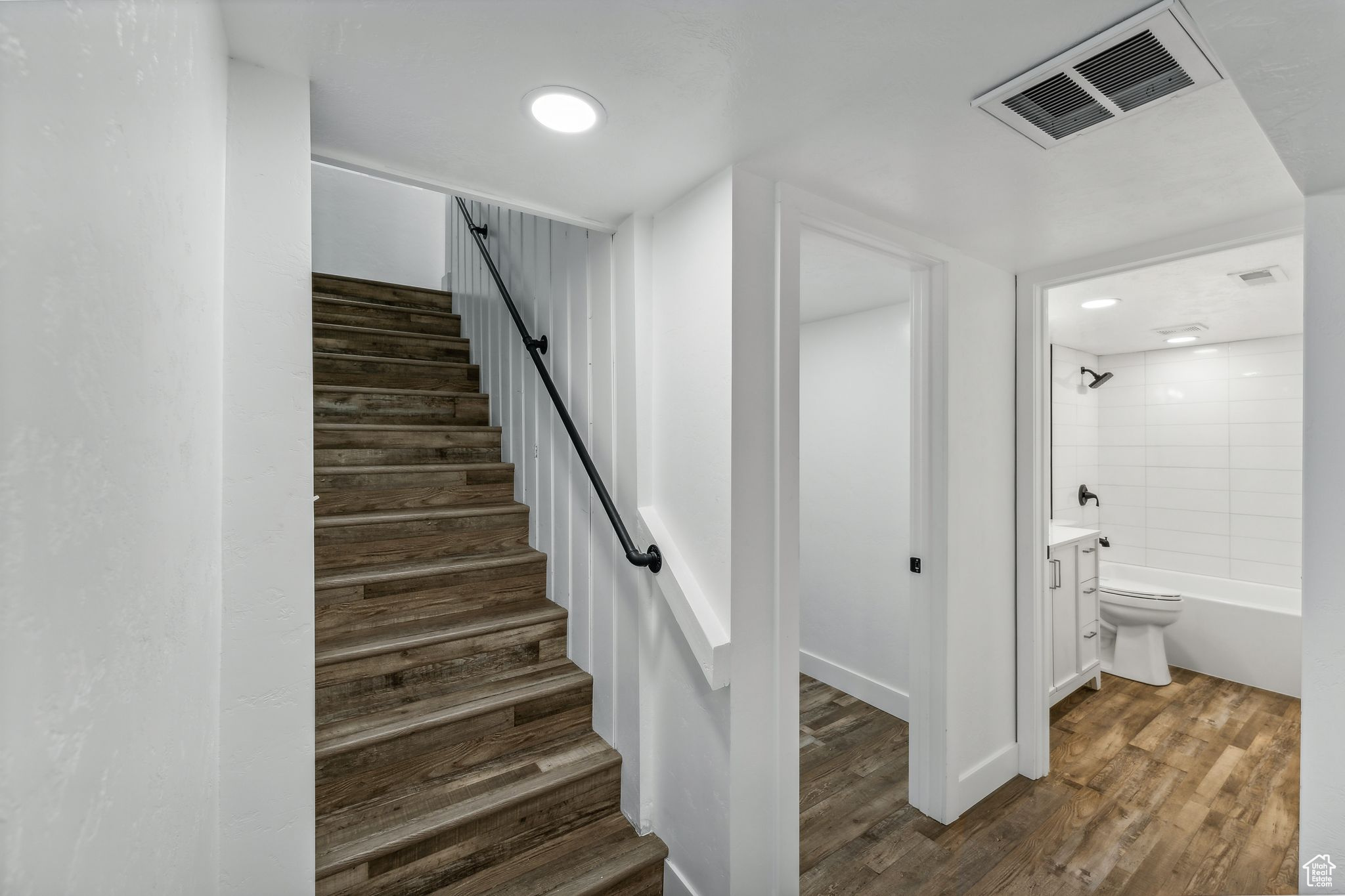 Stairs featuring wood-type flooring