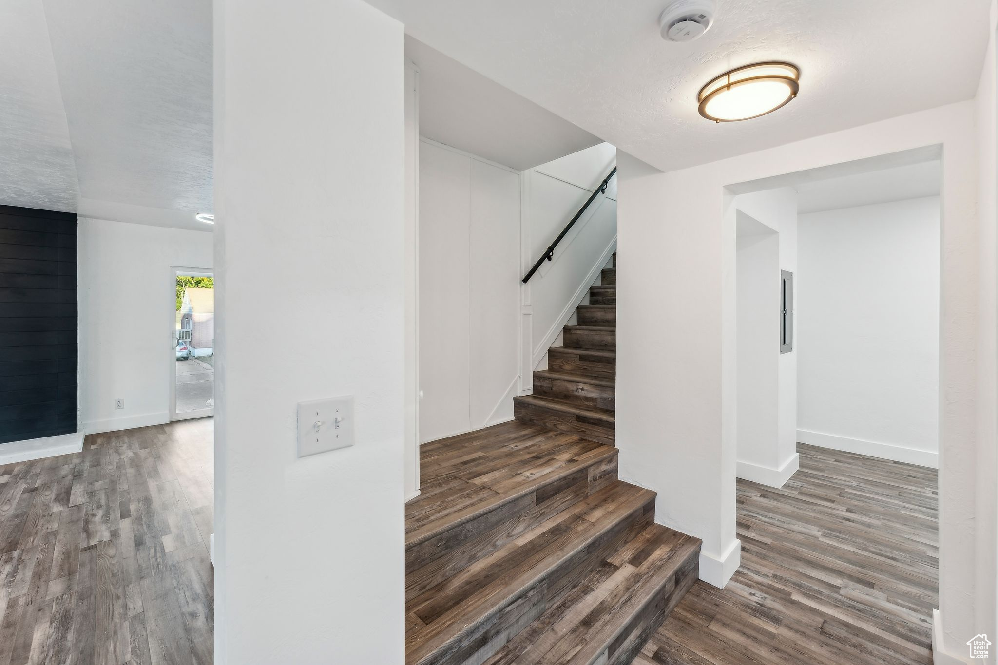 Staircase featuring hardwood / wood-style flooring and a textured ceiling