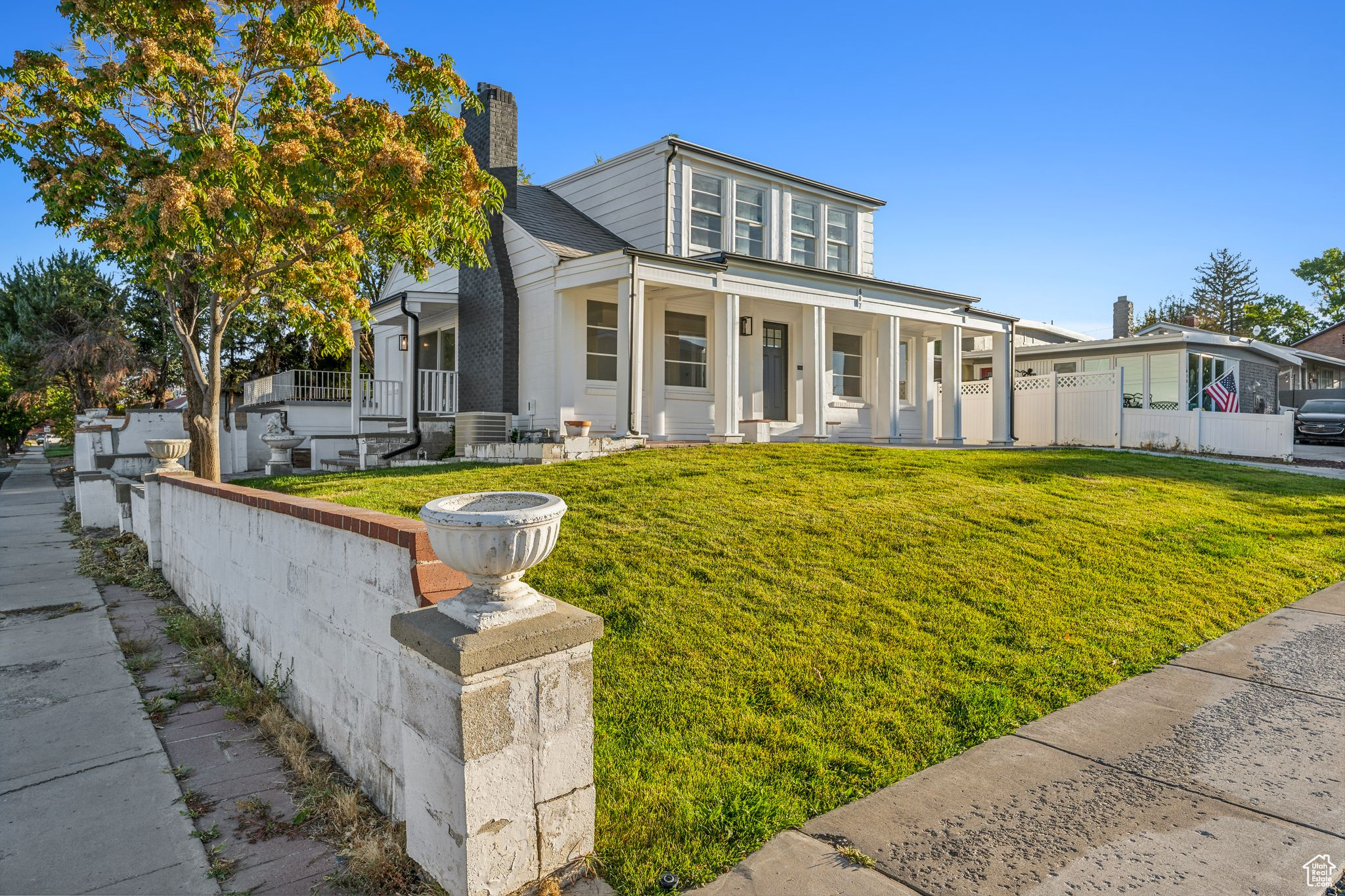 View of front facade with central AC, a front lawn, and a porch