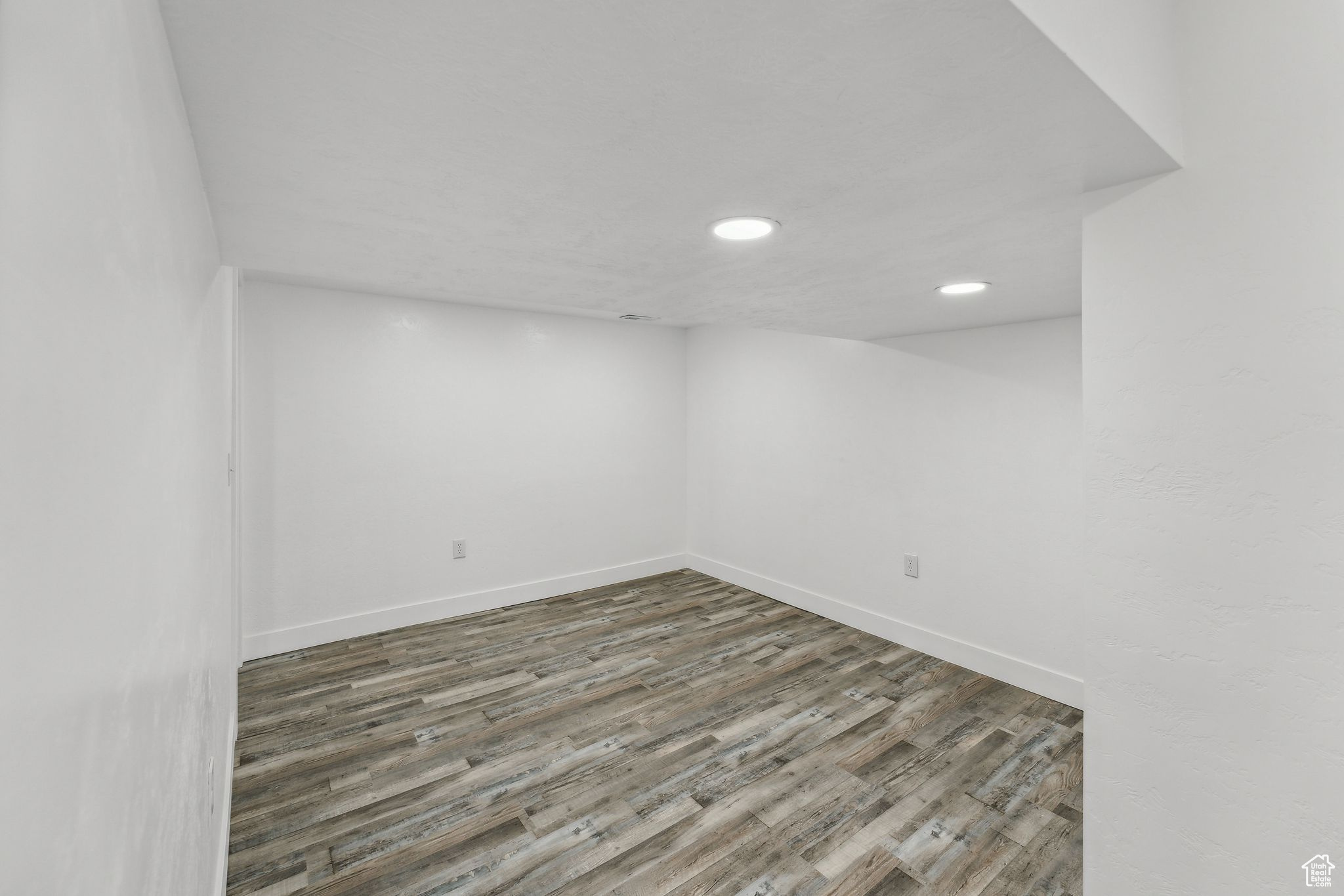 Empty room featuring dark wood-type flooring