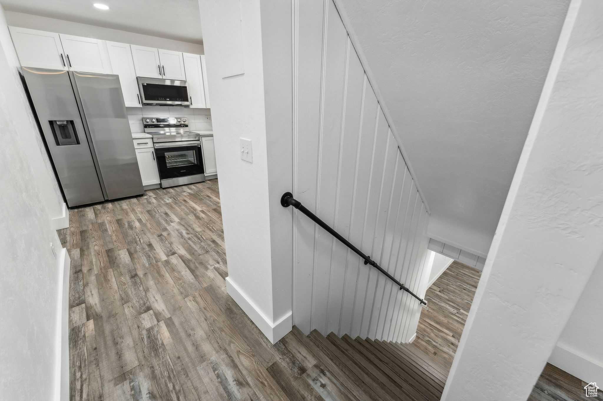 Stairway with hardwood / wood-style floors