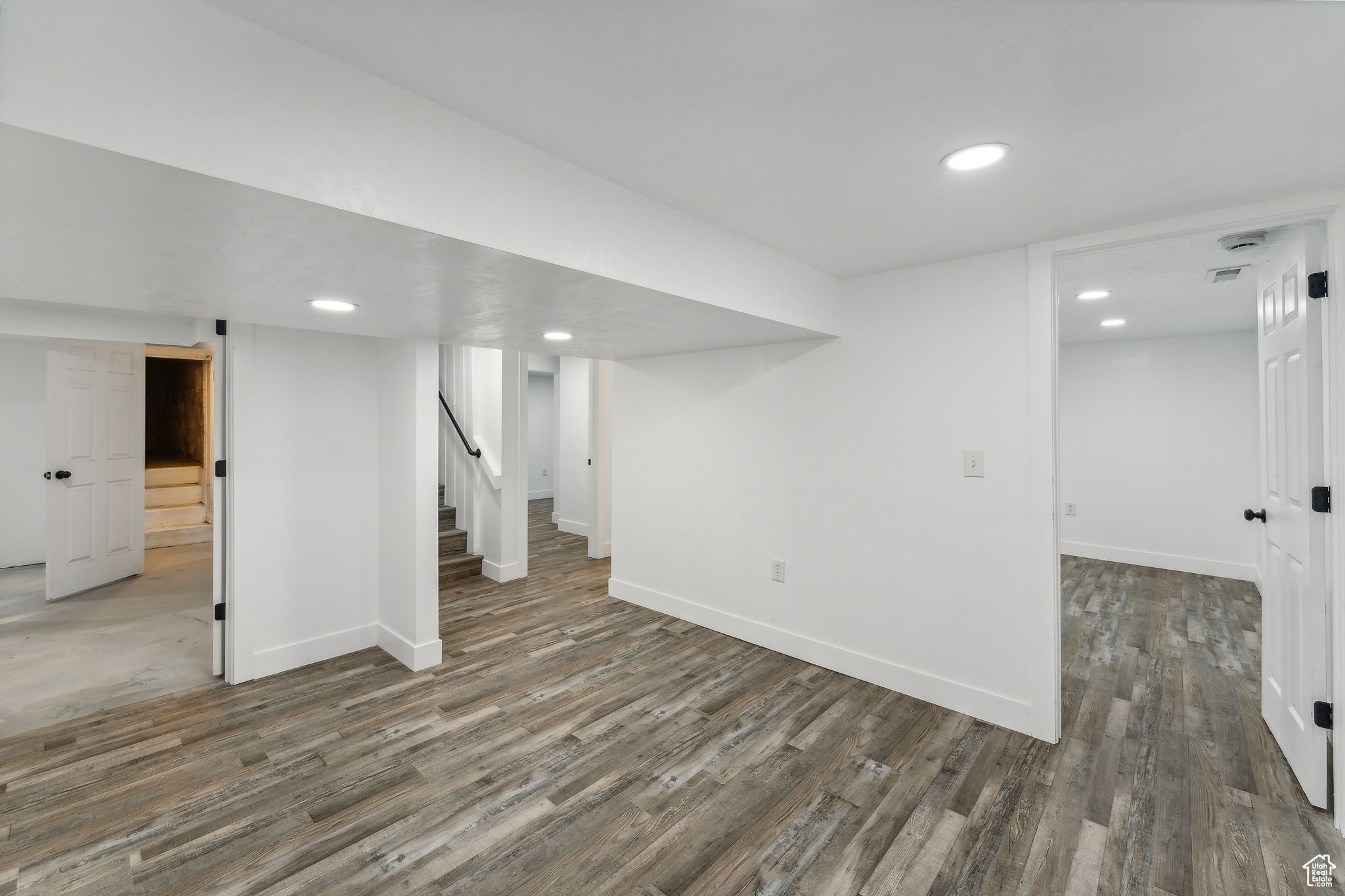 Basement with dark wood-type flooring