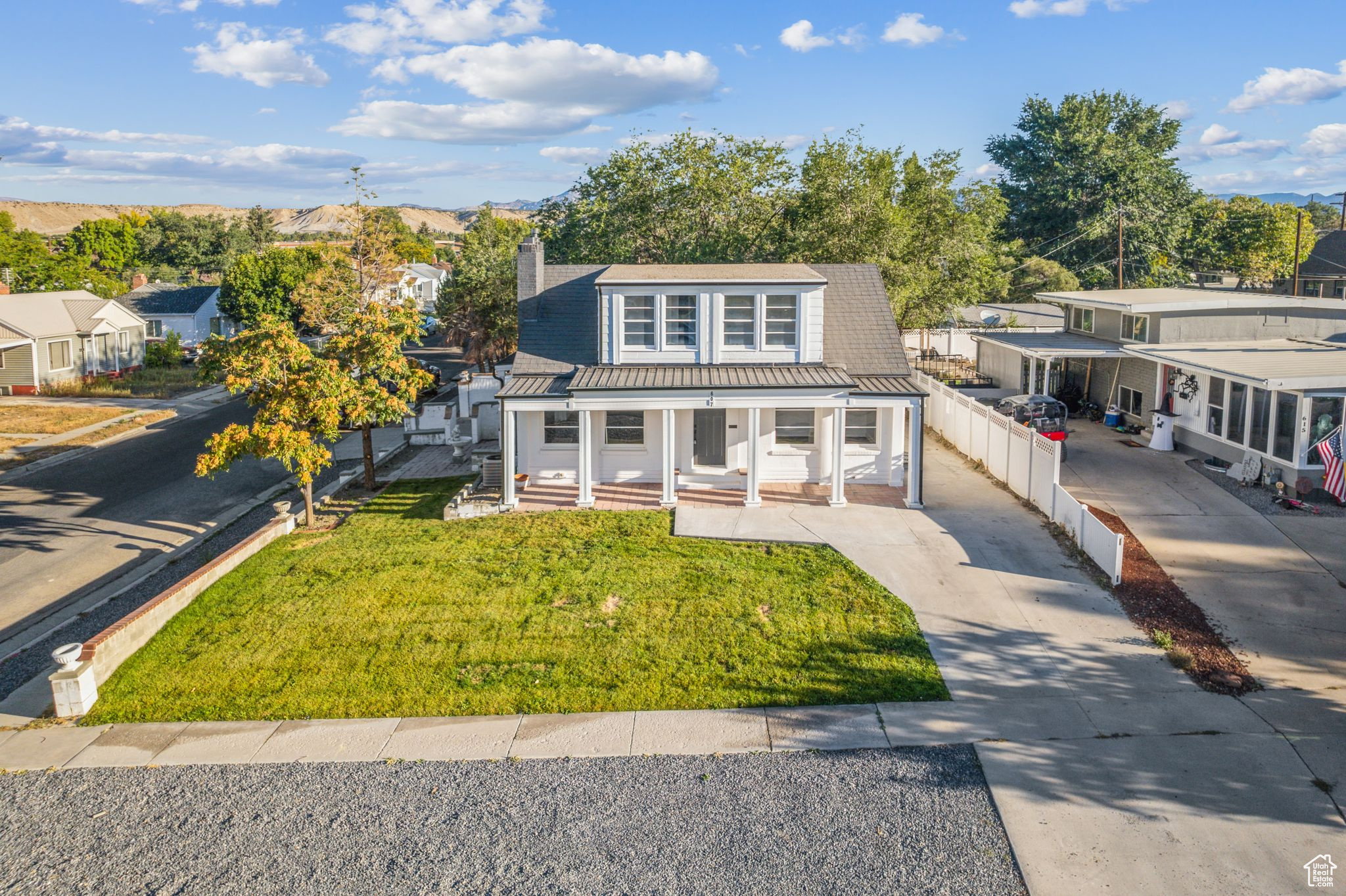 View of front of home with a front lawn and covered porch