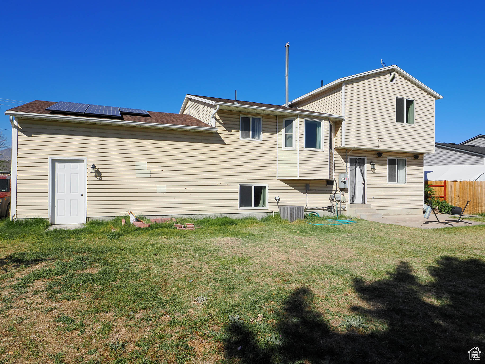 Rear view of house featuring a patio and a yard