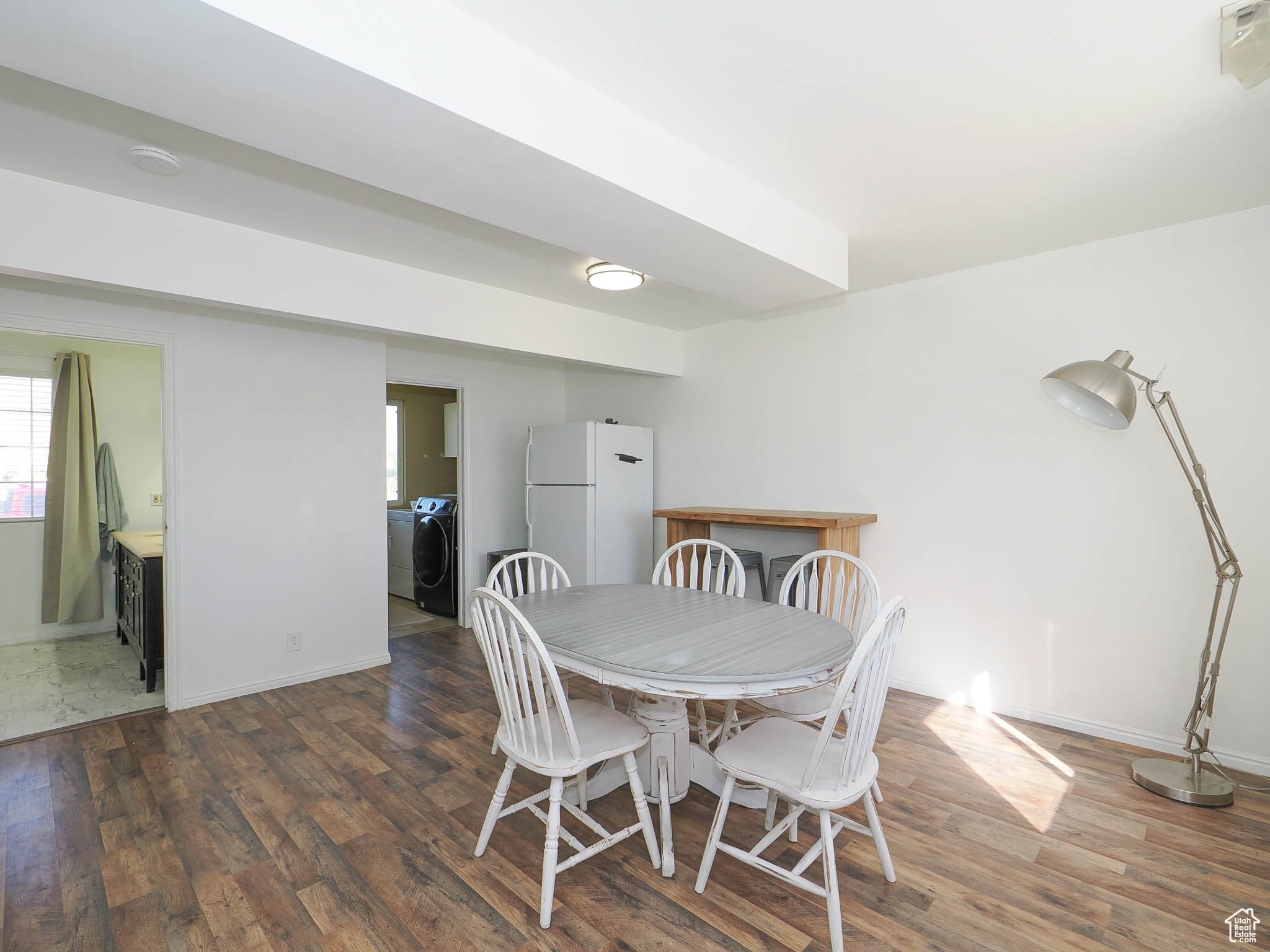 Dining space with washer / clothes dryer and dark hardwood / wood-style flooring