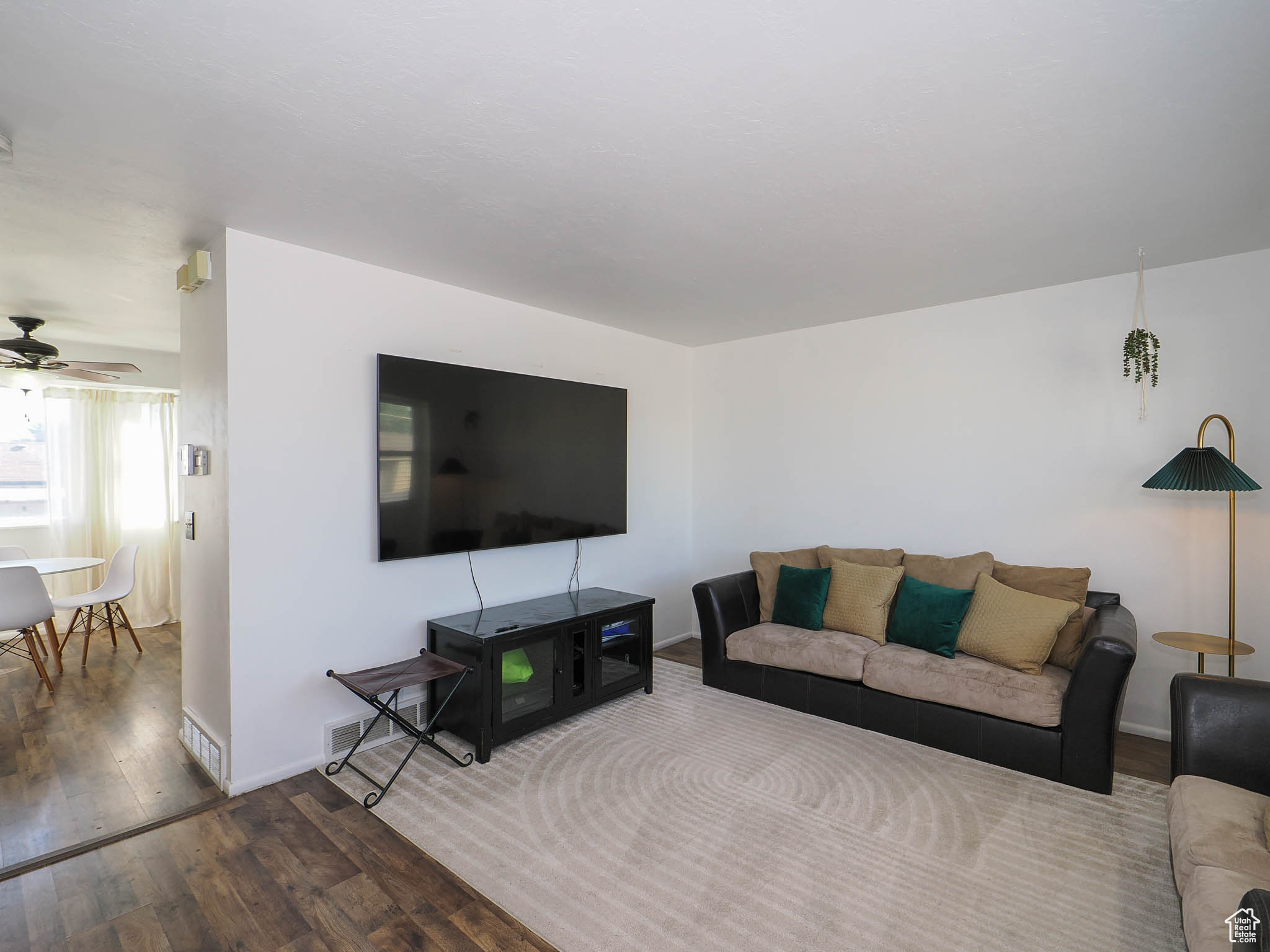 Living room with wood-type flooring and ceiling fan