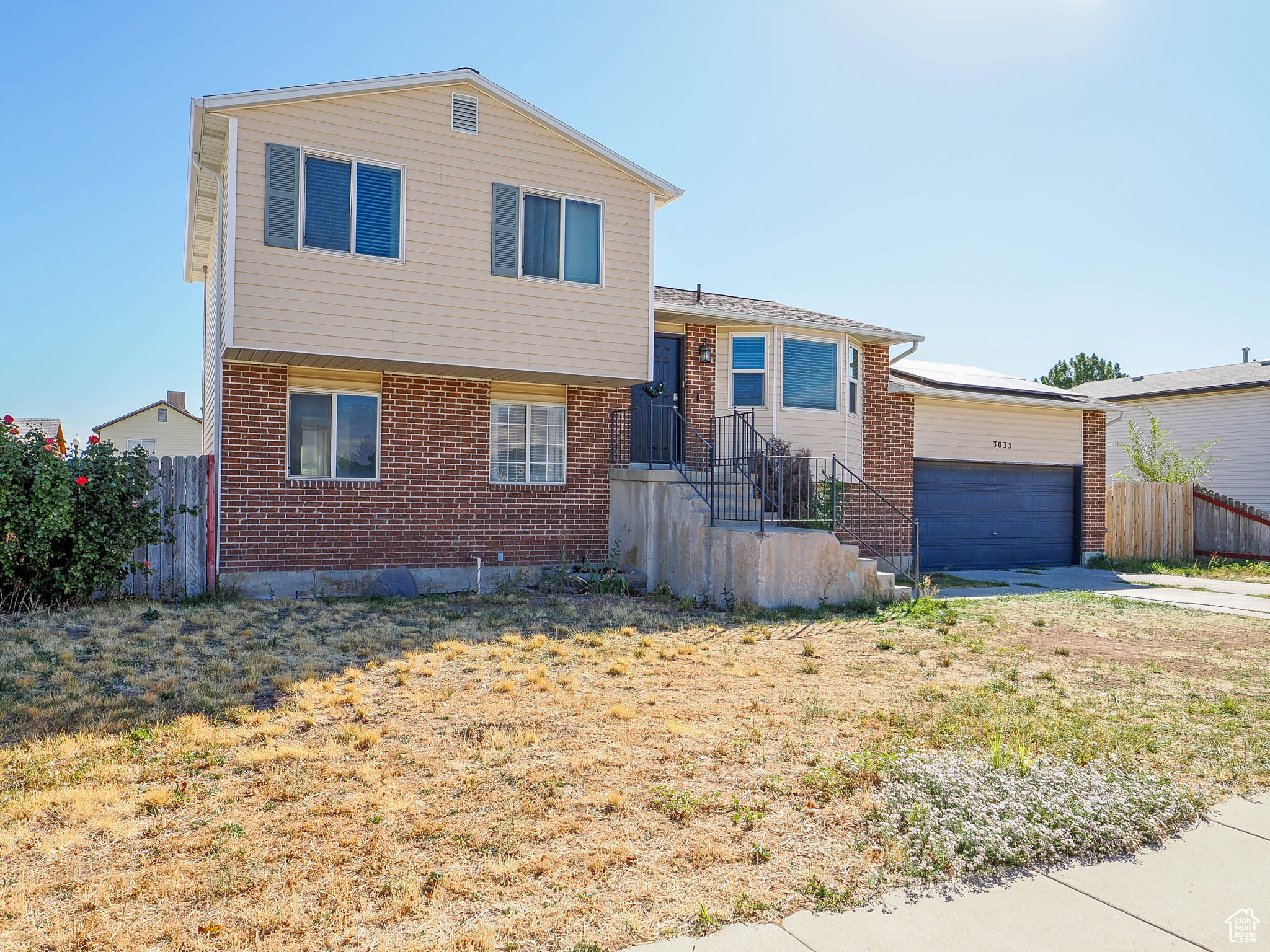 Split level home with a front lawn