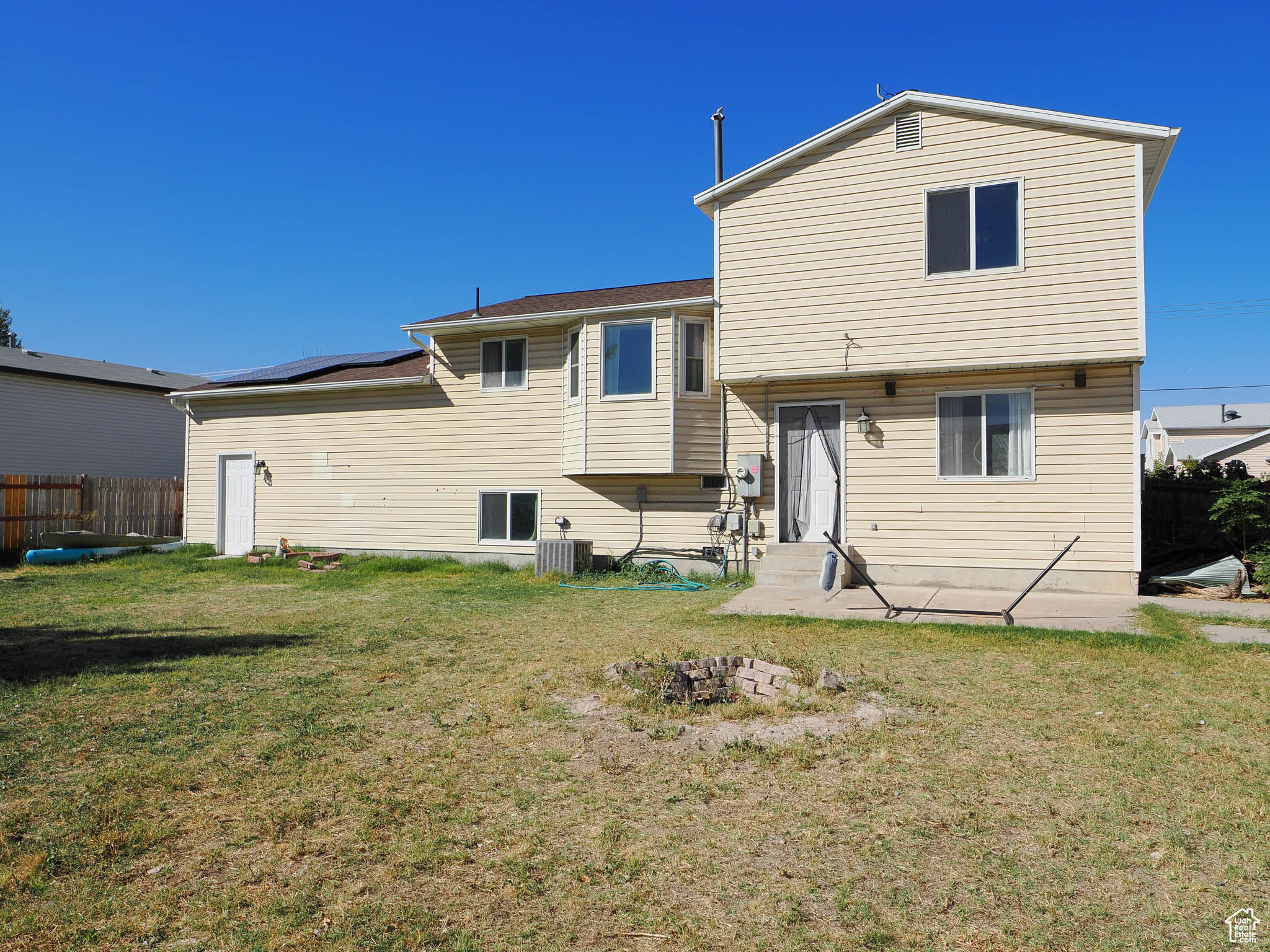 Rear view of property featuring a yard