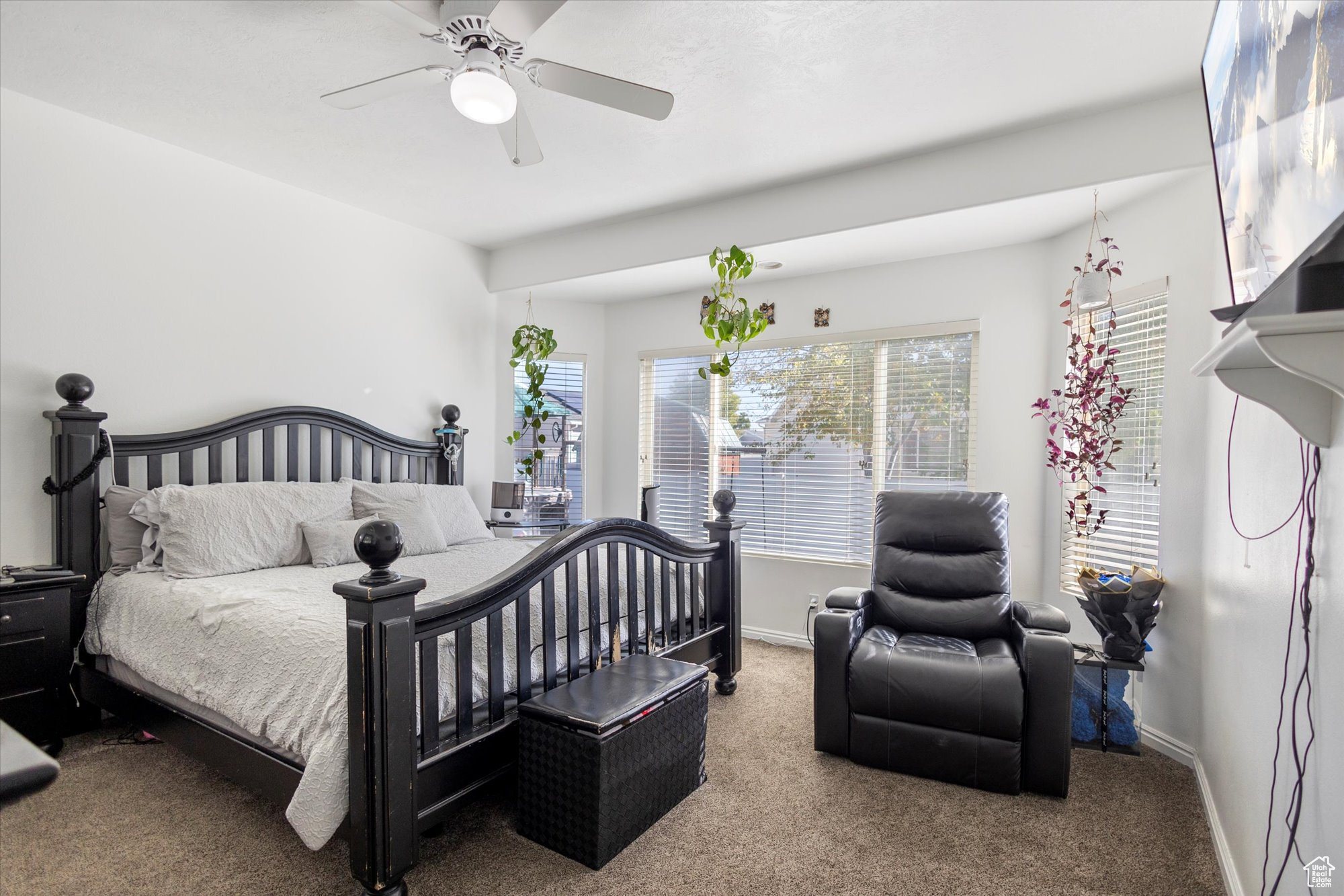 Bedroom featuring ceiling fan and carpet floors