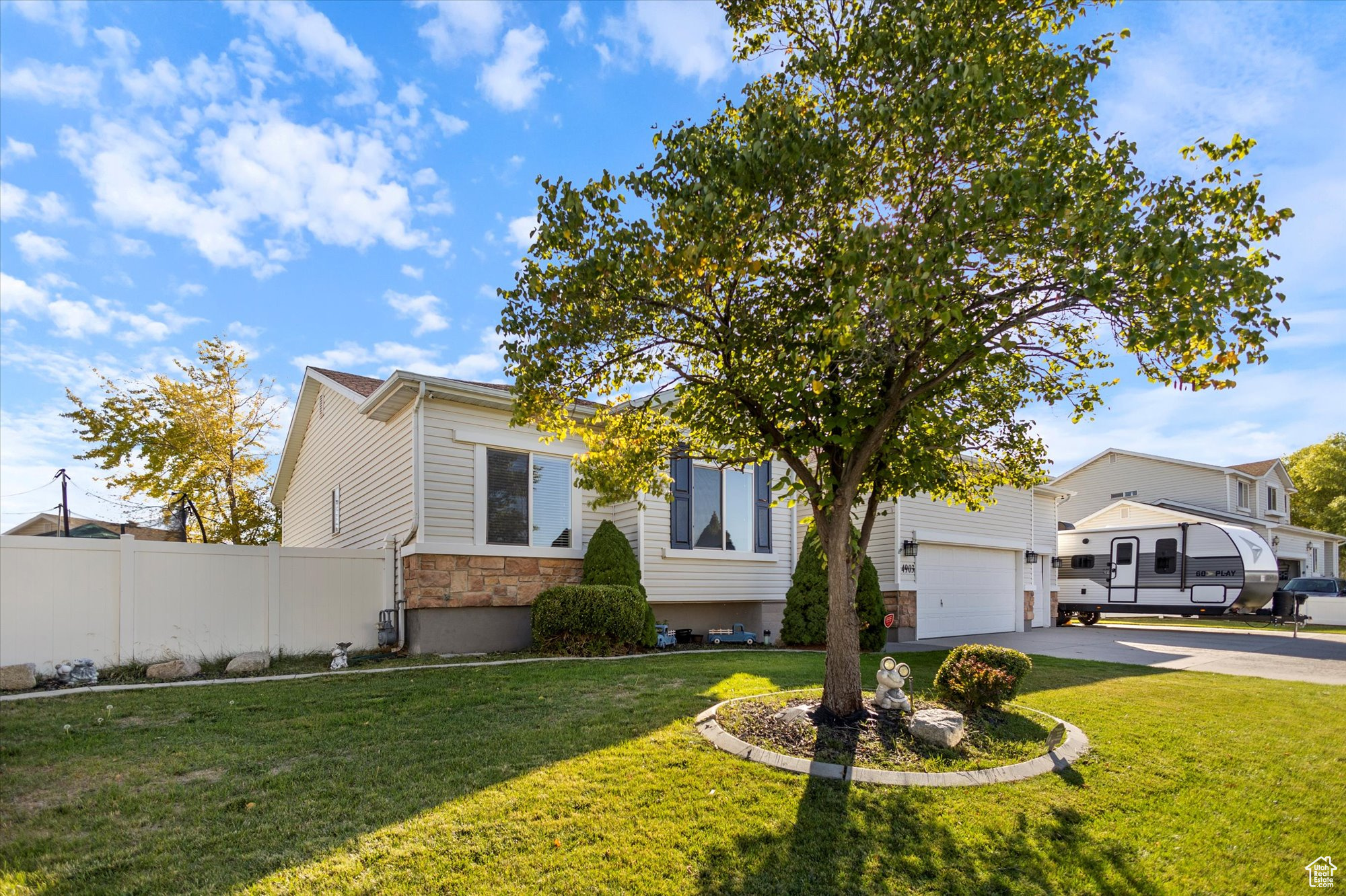 View of front of property featuring a garage and a front yard