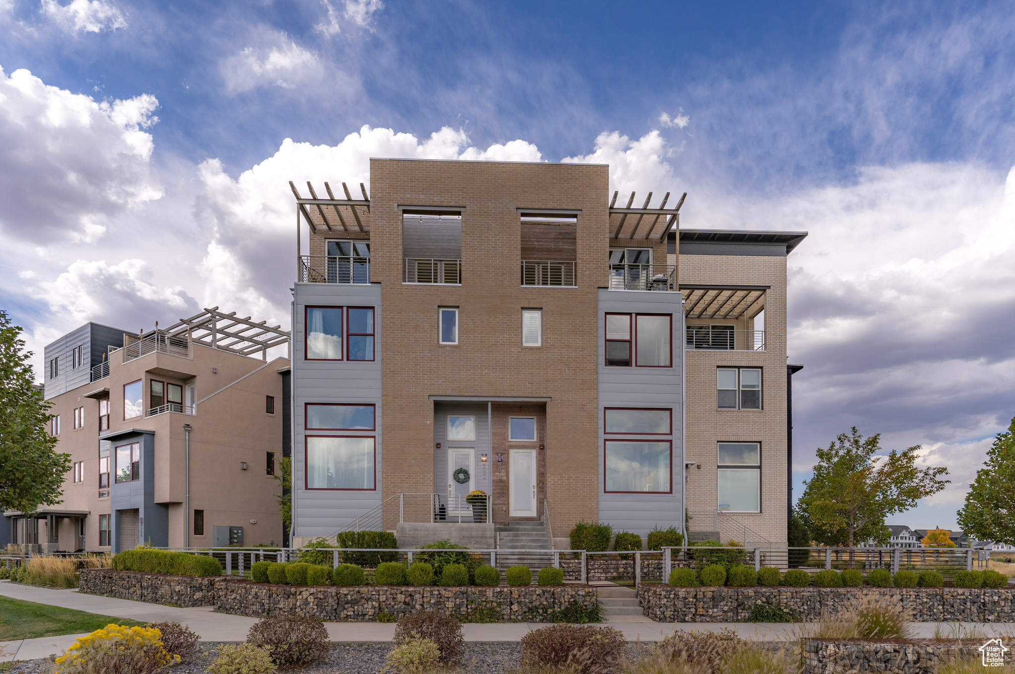 The glorious, reflective windows throughout this modern home deliver breathtaking views while offering enhanced privacy and beauty as it mirrors the sky to passers-by below.